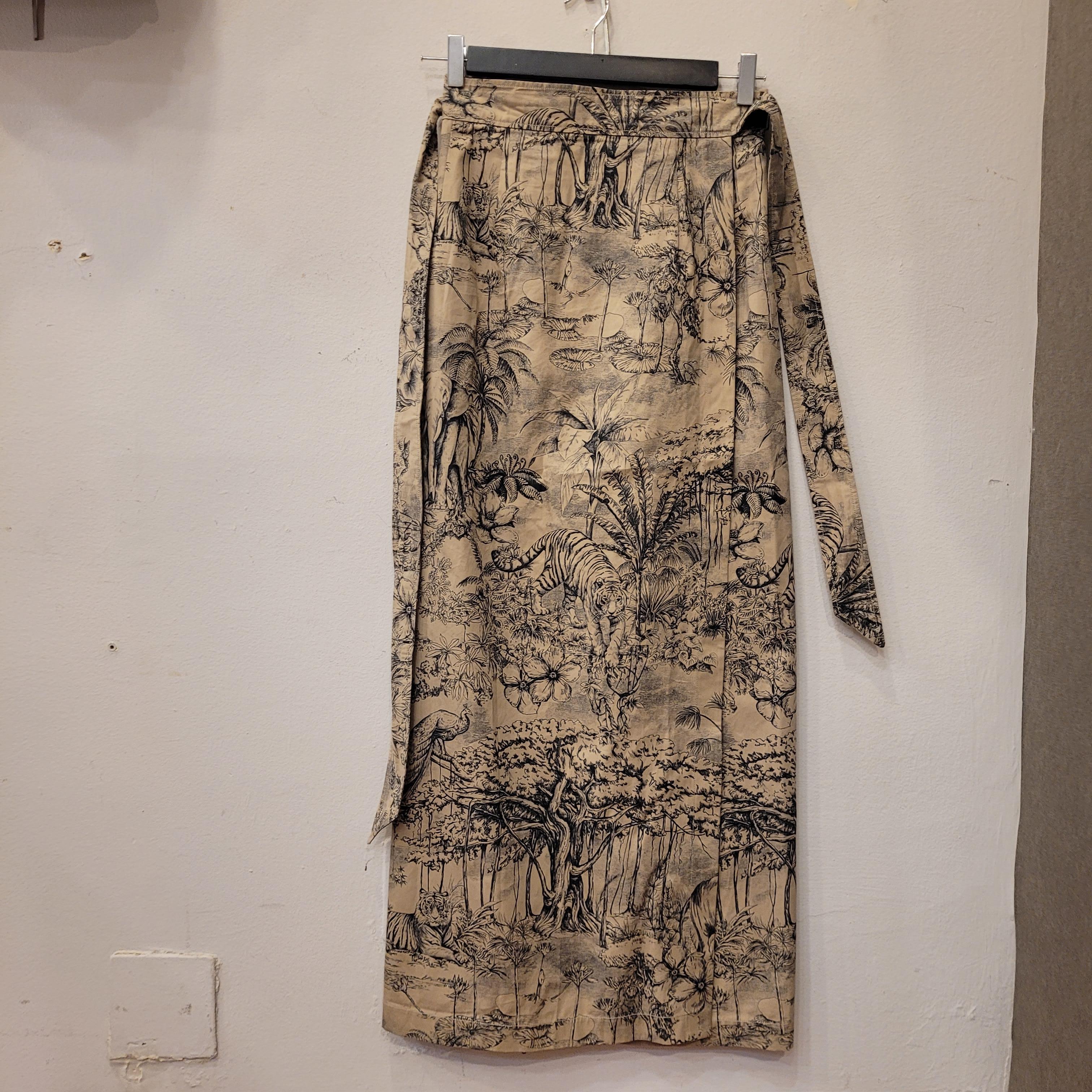 Beautiful long skirt from the Christian Dior 2023 Indiana collection, with a portfolio  or wrap design and decorated with the Indian garden motif in vivid shades of black, beige and gray, gorgeous animals like tiger or elephant walking in the