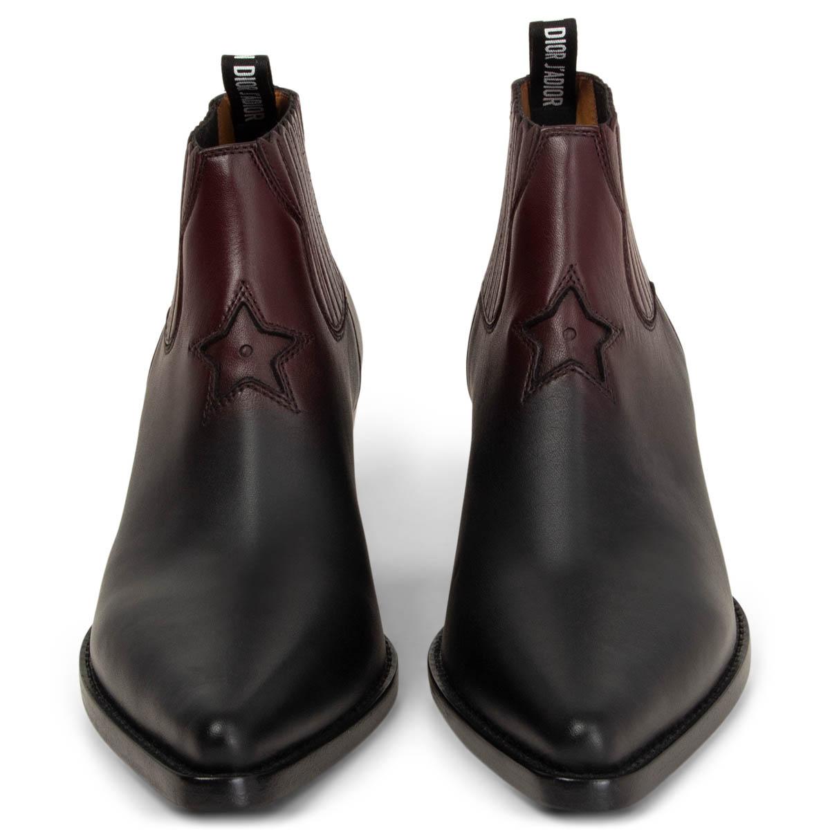100% authentic Christian Dior star ankle cowboy boots in black and burgundy calfskin featuring a pointed toe and logo pull tab at the rear with decorative star detail to the front. Elastic inserts on the side. Brand new. Rubber sole got added. Come