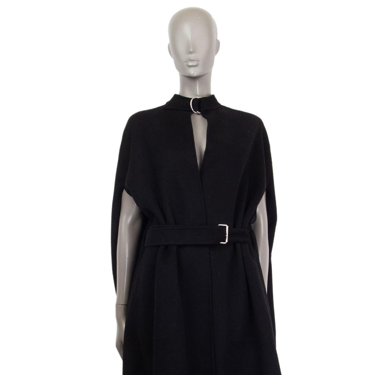 authentic Christian Dior belted cape in black cashmere blend (missing tag). Unlined with two inside pockets and a buttoned pleat on the back. Has been worn and is in excellent condition. 

Tag Size OS
Size one size
Length 119cm (46.4in)
