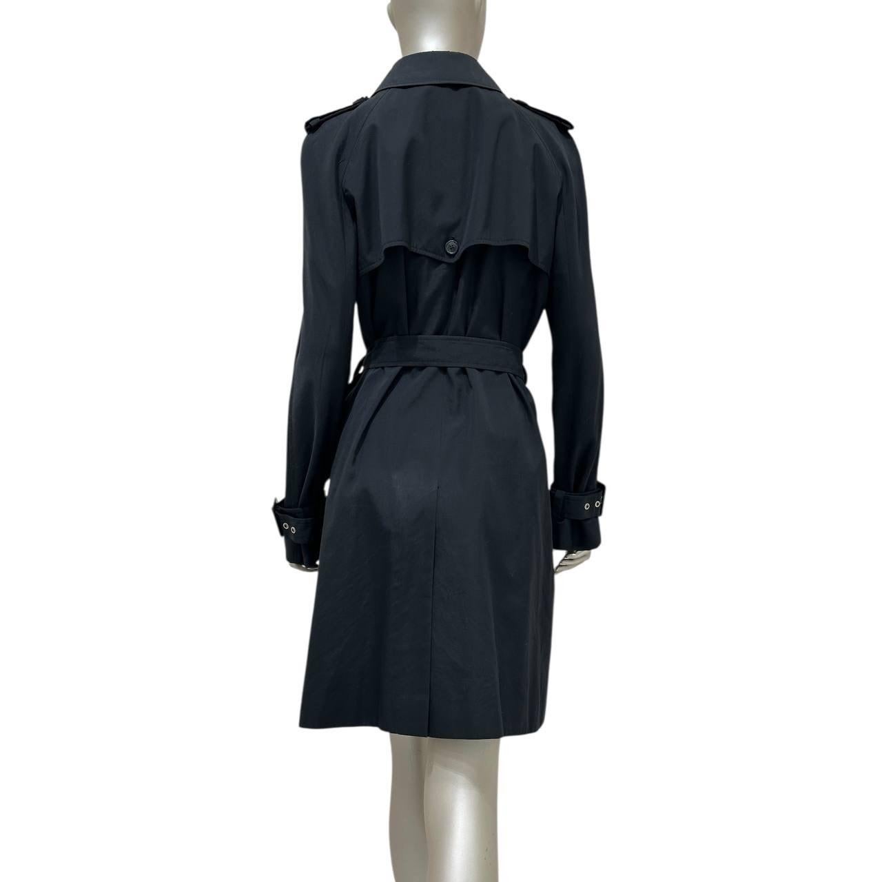 This Christian Dior black cotton trench coat is a timeless and elegant piece. It is in very good condition and ready to elevate your wardrobe. The classic design and high-quality material make it a perfect addition to any outfit. Don't miss the