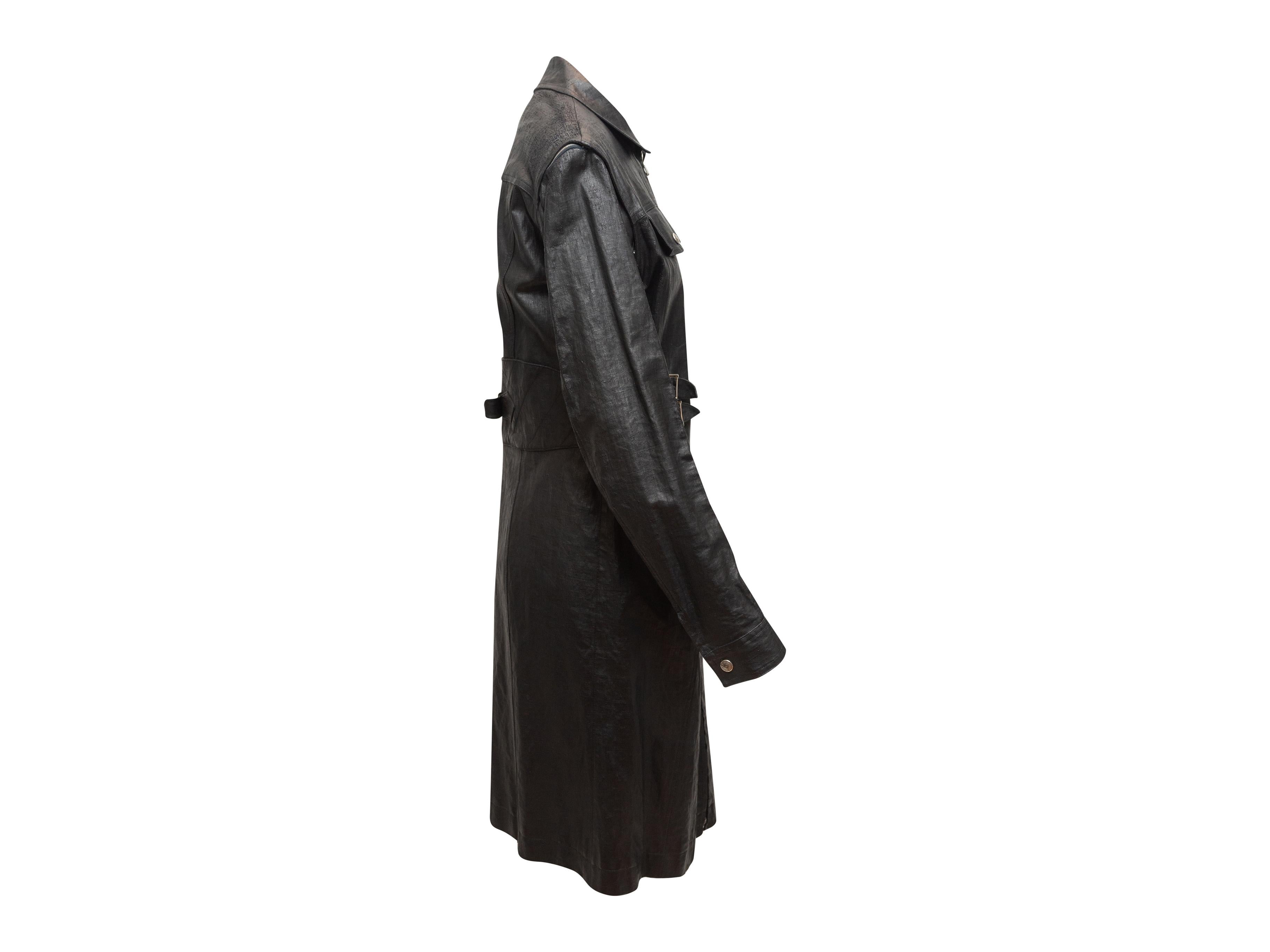 Product details: Black long waxed coat by Christian Dior. From the John Galliano Era. Pointed collar. Dual flap pockets at bust. Buckle accents at waist sides. Dual hip pockets. Zip-off sleeves. Zip closure at center front. 36
