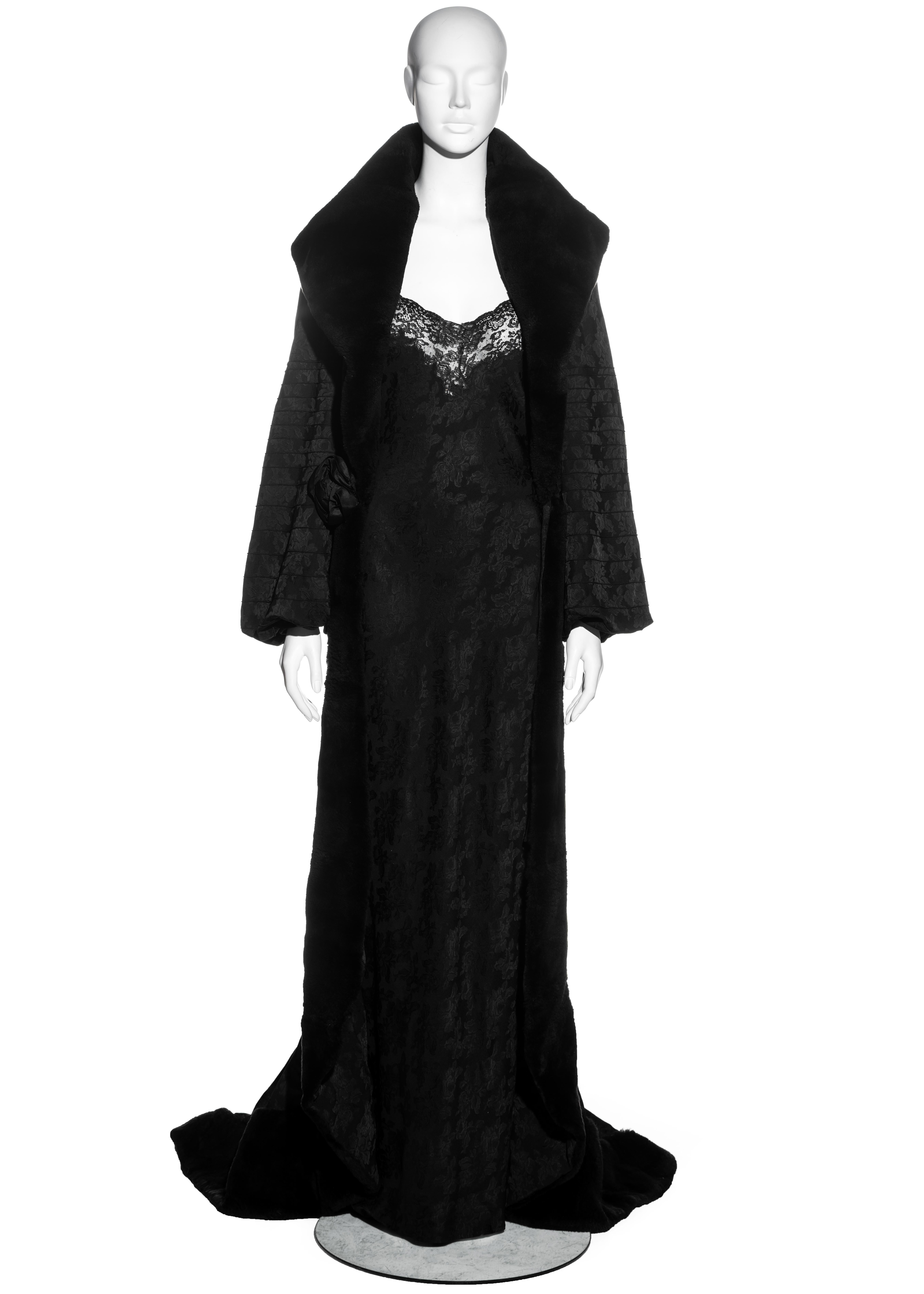 ▪ Christian Dior black jacquard evening coat and dress set
▪ Designed by John Galliano
▪ Jacquard 76% Acetate, 24% Viscose
▪ Lining 100% Silk
▪ Large fur collar and trim 
▪ Pin-tucked detail on poet sleeves 
▪ Silk rosette appliques at centre