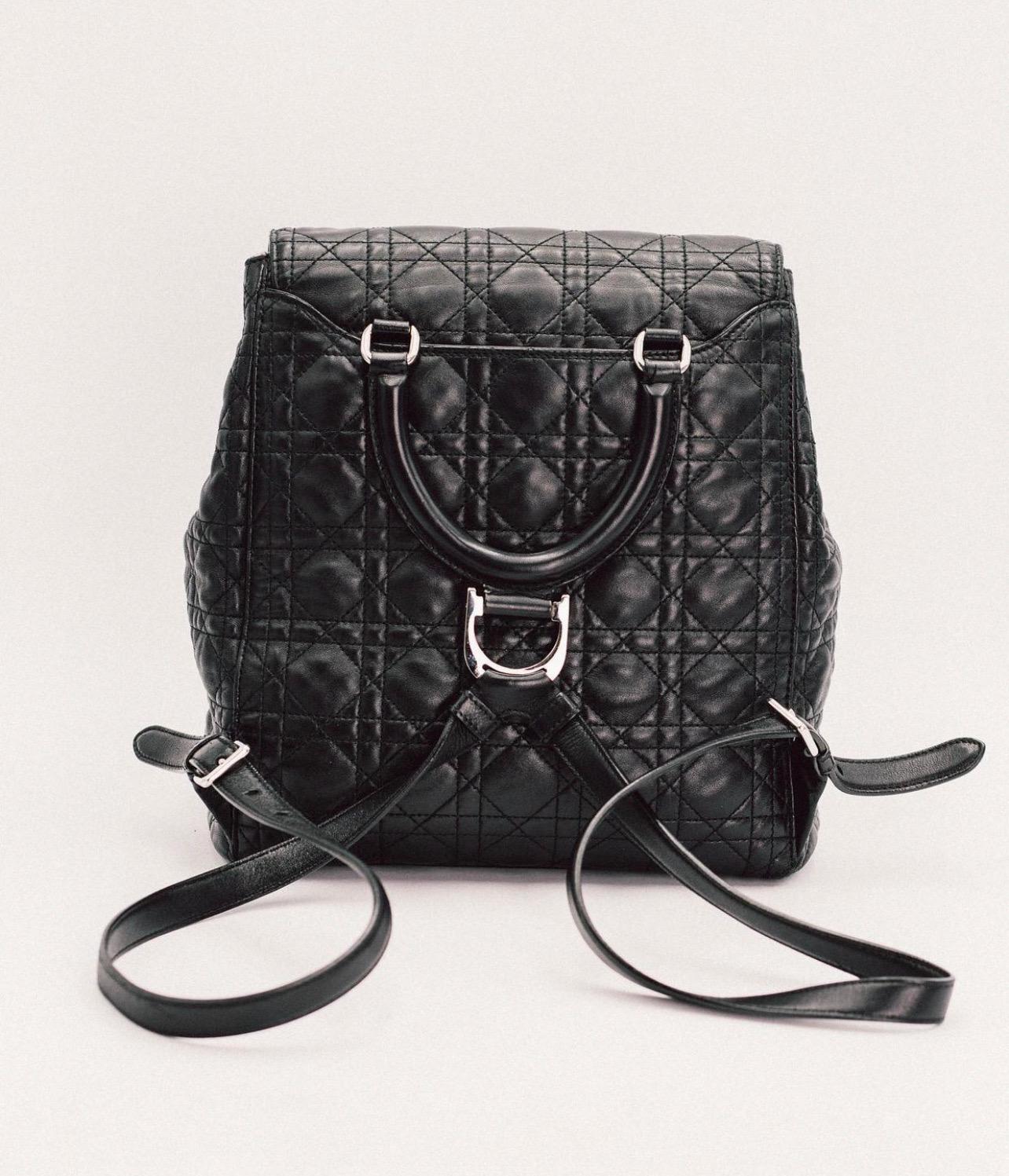 Black Cannage leather Christian Dior Large Stardust Backpack with silver-tone hardware, dual flat shoulder straps, single pocket at front exterio, logo at front flap, pink grosgrain lining, single pocket at interior wall and magnetic snap closure at