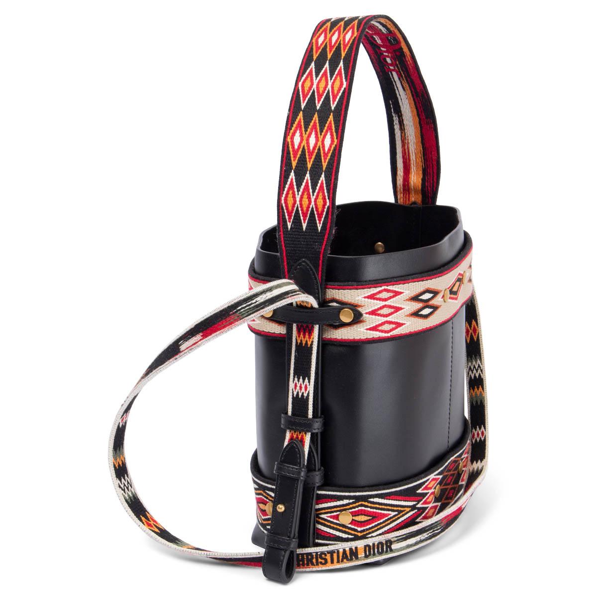 100% authentic Christian Dior Diorodeo Small Hobo small bucket style bag is crafted of smooth black leather, canvas and multicolor stitched fabric. Embroidered logo shoulder-strap. The bag opens to a black suede interior with three patch pockets.