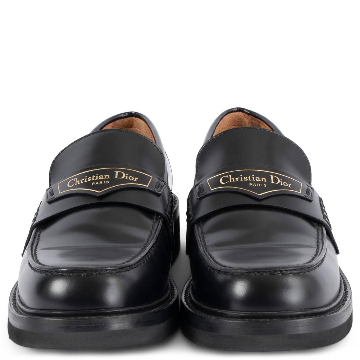 100% authentic Christian Dior Boy loafers in black calfskin featuring gold-tone 'Christian Dior PARIS' signature on a leather tag in the front and a black rubber sole. Have been worn once or twice and are in virtually new condition.