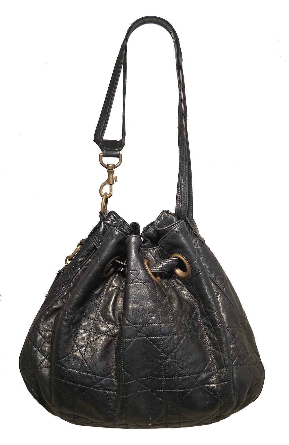 Christian Dior Black Leather Cannage Drawstring Shoulder Bag in very good condition. black cannage quilted leather trimmed with antiqued bronze hardware. Drawstring style top opens to a red nylon lined interior with one zip and 2 slit side pockets.