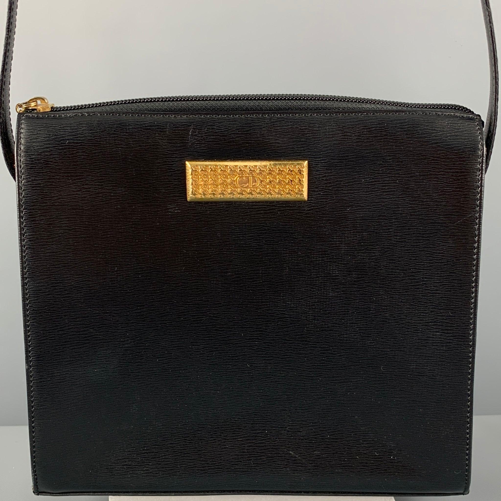 Vintage CHRISTIAN DIOR handbag comes in a black leather featuring a shoulder strap, inner pocket, and a zipper closure. Made in France. Very Good Pre-Owned Condition. Minor signs of wear. 

Measurements: 
  Length: 9 inches Width: 2.75 inches