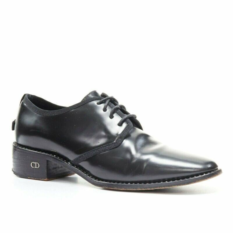 CHRISTIAN DIOR black leather grosgrain trimmed laced crystal outsole oxford EU38
Reference: TGAS/A03314
Brand: Christian Dior
Material: Leather
Color: Black
Pattern: Solid
Extra Details: Black polished leather upper. Almond round toe. Grosgrain