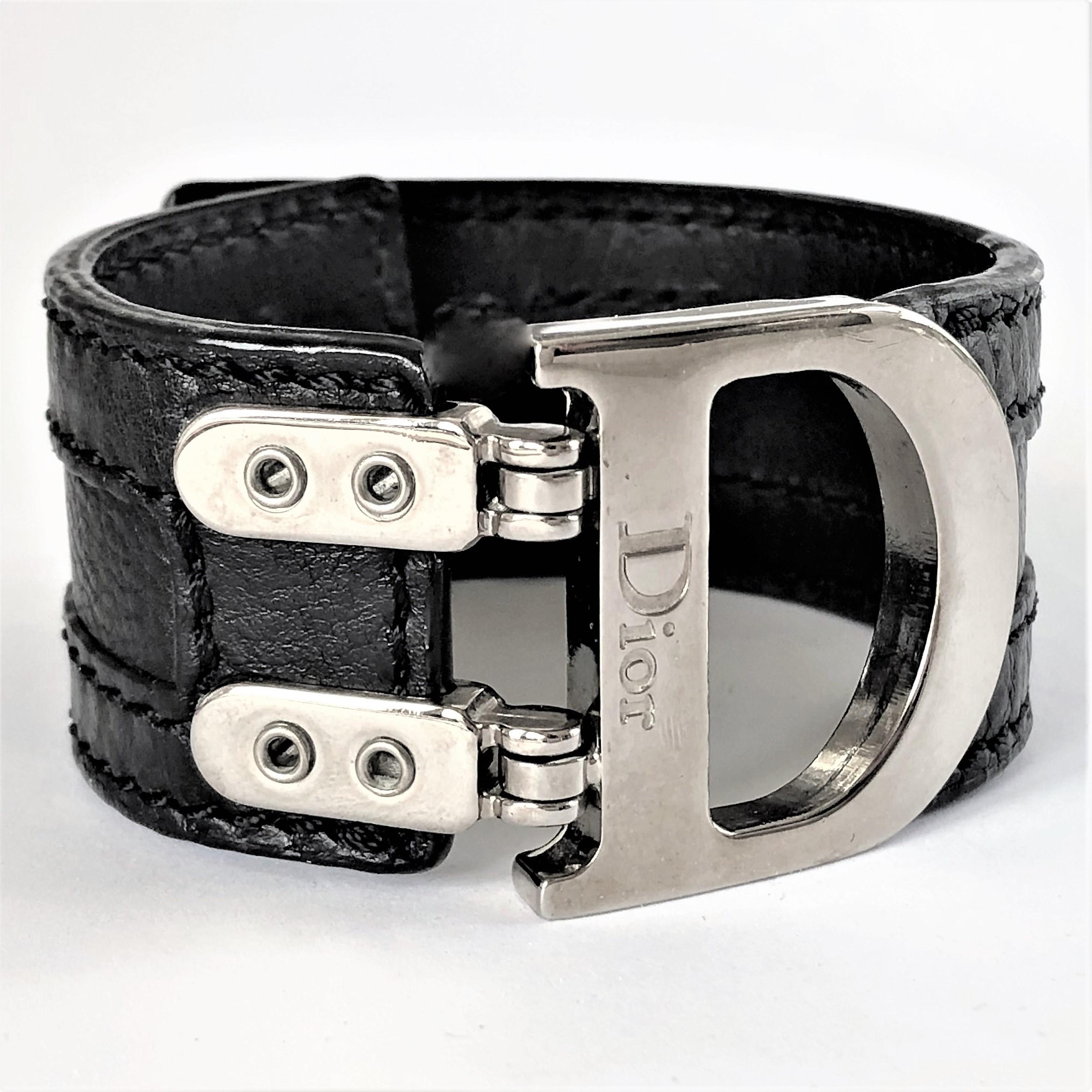 Featured in 2005-2006, this stylish, black leather cuff by Christian Dior, is a great accessory.
The Palladium finish metal buckle with the iconic 