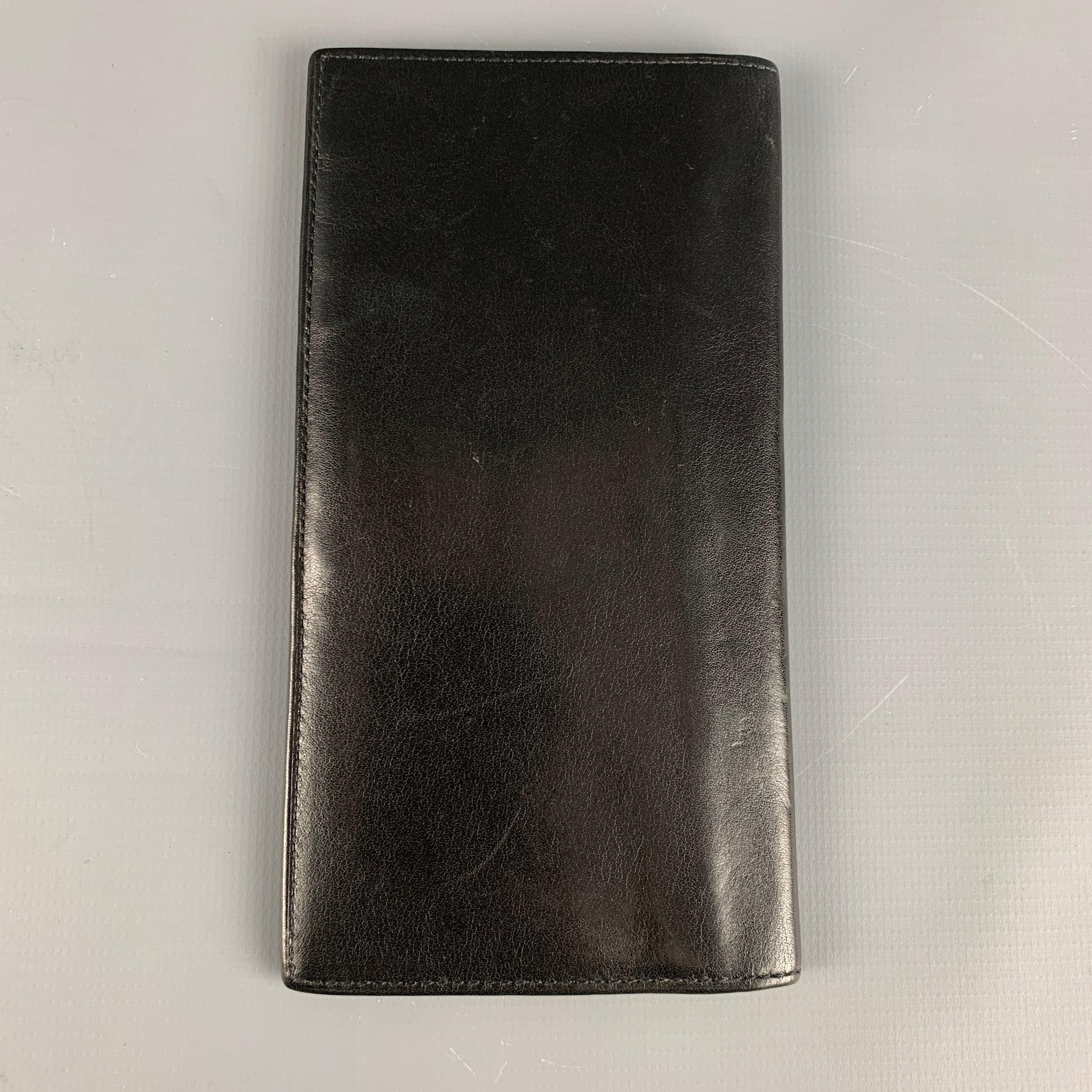 CHRISTIAN DIOR VINTAGE wallet comes in black leather with a folder design and inner slots.Very Good Pre-Owned Condition.7 x 3.5 inches  
  
  
 
Reference: 126035
Category: Wallet
More Details
    
Brand:  CHRISTIAN DIOR
Color:  Black
Material: 