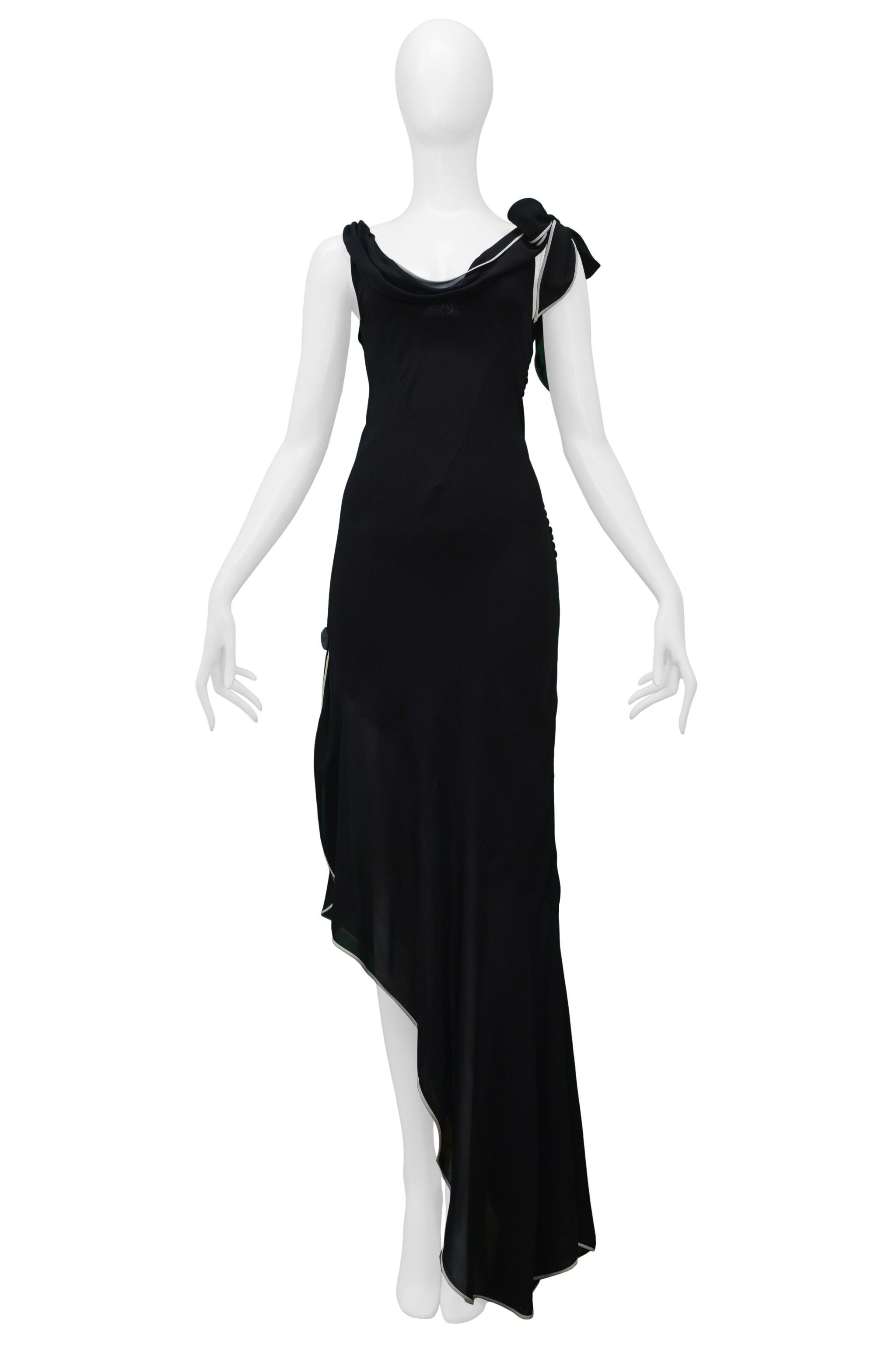 Resurrection is excited to offer a vintage Christian Dior black evening gown featuring chiffon ruffles, a tie strap, white contrasting trim, asymmetrical skirt, side buttons, and decorative 
