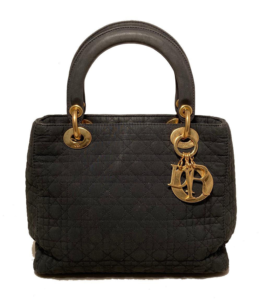 Dior Vintage  Medium Lady Dior Black Nylon Cannage Quilted Bag in very good condition. Black nylon cannage quilted body trimmed with gold hardware and black nylon handles. Top flap snap closure opens to a red nylon interior that holds one side