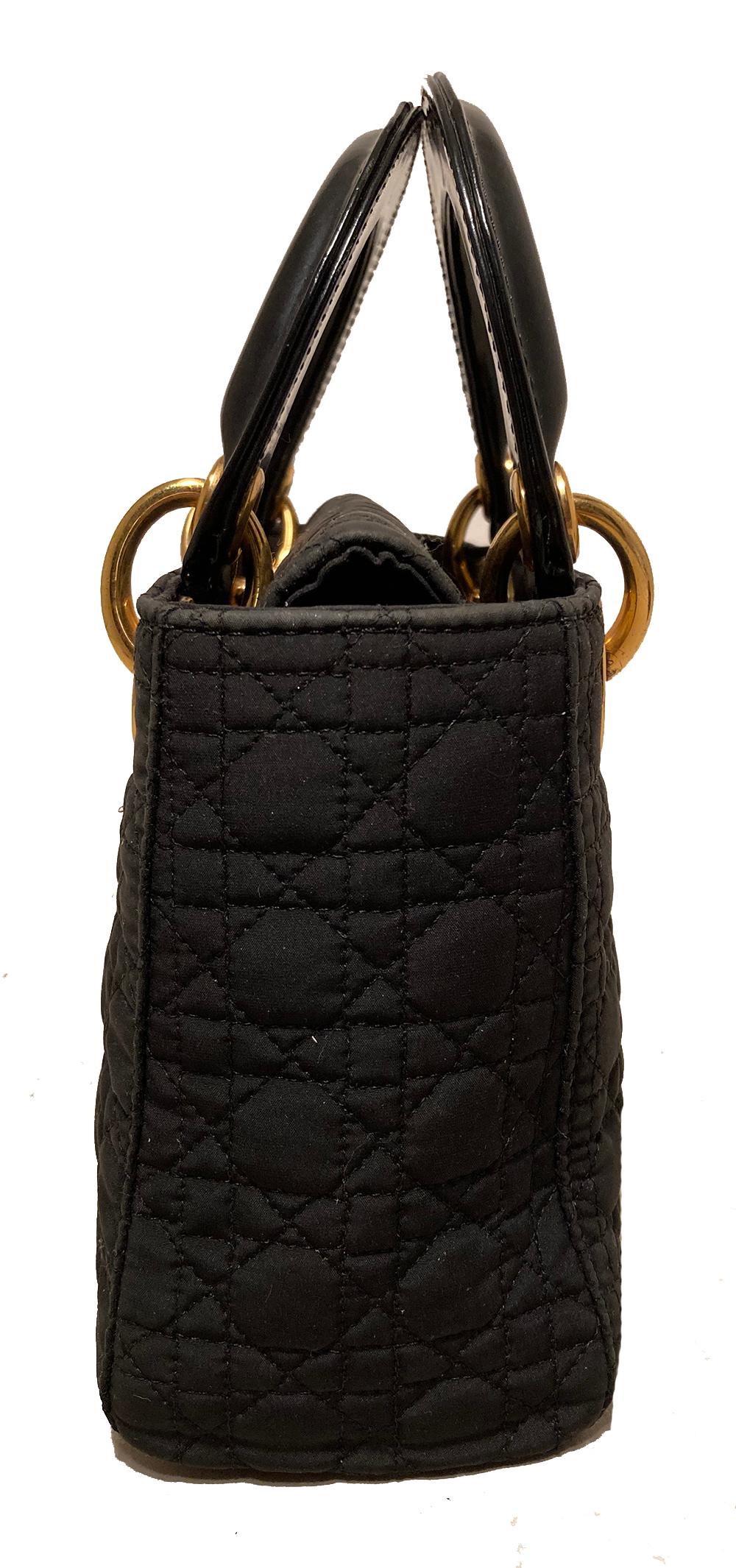Dior Vintage Mini Lady Dior Black Nylon Cannage Quilted Bag in very good condition. Black nylon cannage quilted body trimmed with gold hardware and black leather handles. Top flap snap closure opens to a red nylon interior that holds one side zipped