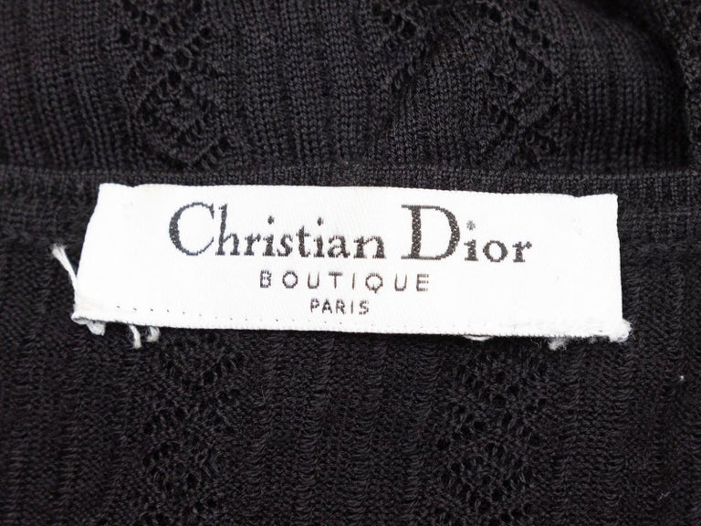 Product Details: Black open knit long sleeve sweater by Christian Dior. Plunging V-neckline. 42