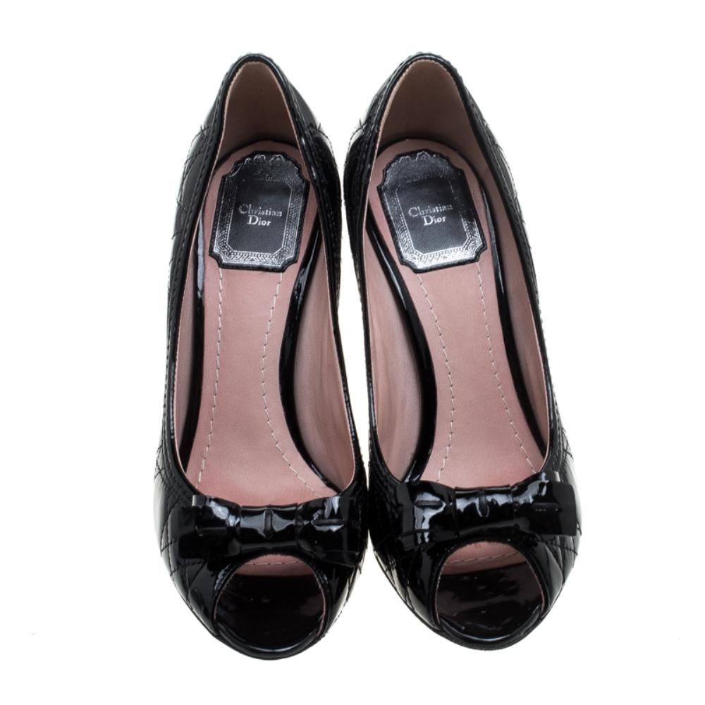 Christian Dior designs ensure to grant you fashion excellence, and these pumps are no different. They are constructed with black patent leather featuring Cannage pattern throughout the exterior and leather bows on the vamps. These pretty pumps are