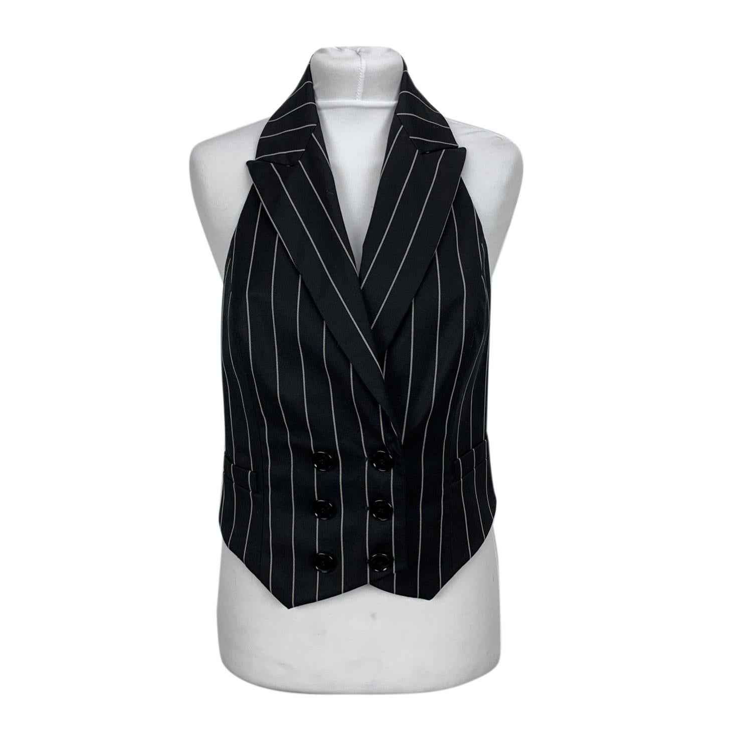 Christian Dior pinstriped vest. The vest features a double-breasted and backless design. Composition: 100% wool. Size: 38 F, 10 GB, 42 IT, 36 D, 6 USA (The size shown for this item is the size indicated by the designer on the label). It should