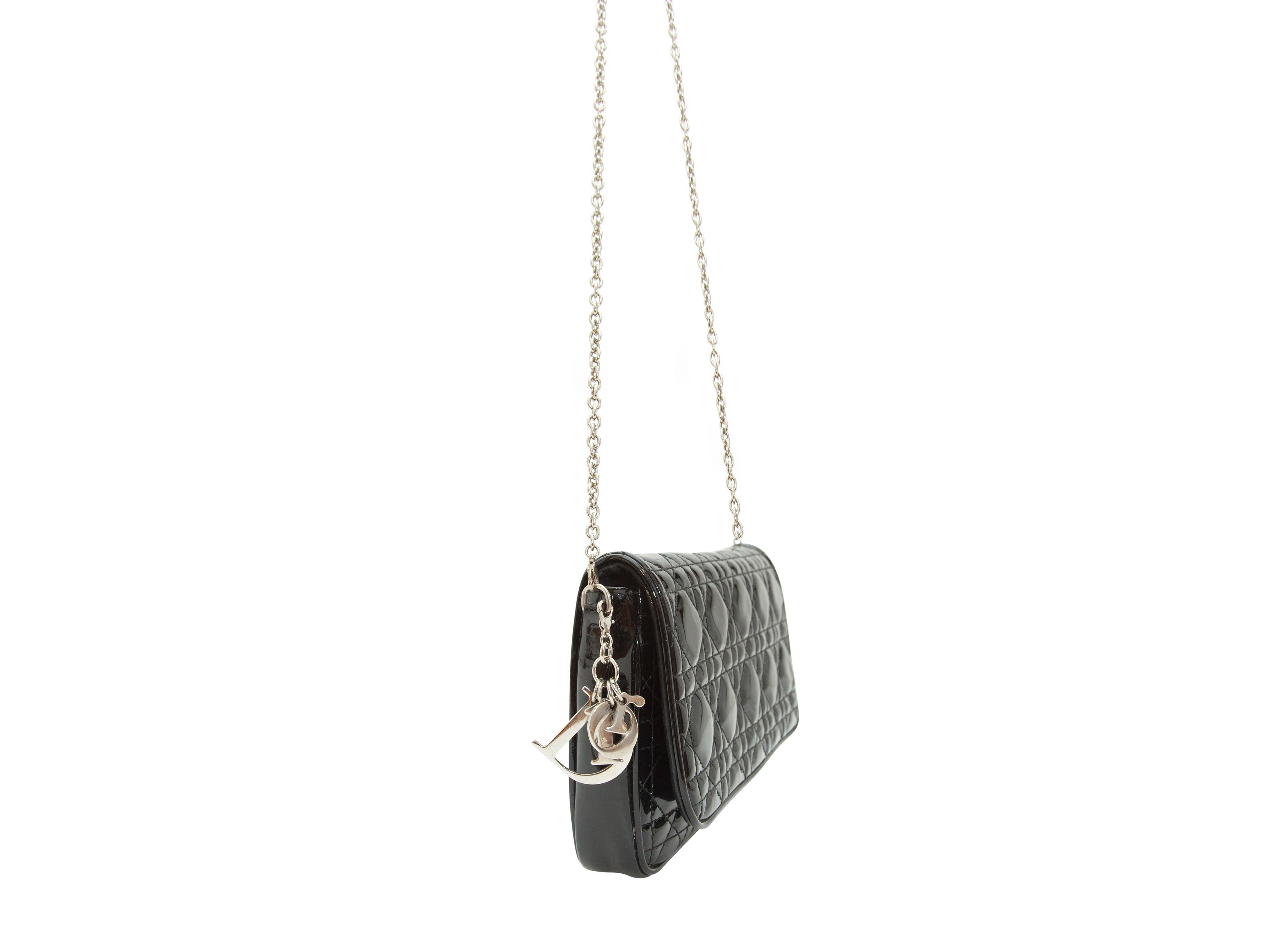 Product details:  Black quilted patent leather crossbody bag by Christian Dior.   Detachable chain crossbody strap.  Front flap with concealed closure.  Lined interior with inner credit card slots.  Silvertone hardware.  9