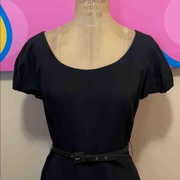 This tailored sheath dress by Christian Dior is lady like glamour ! This classic style will serve you for many years to come. Perfect for special occasions. Pair with nude or black heels and pearls. Comes with a self belt. Black belt on dark navy
