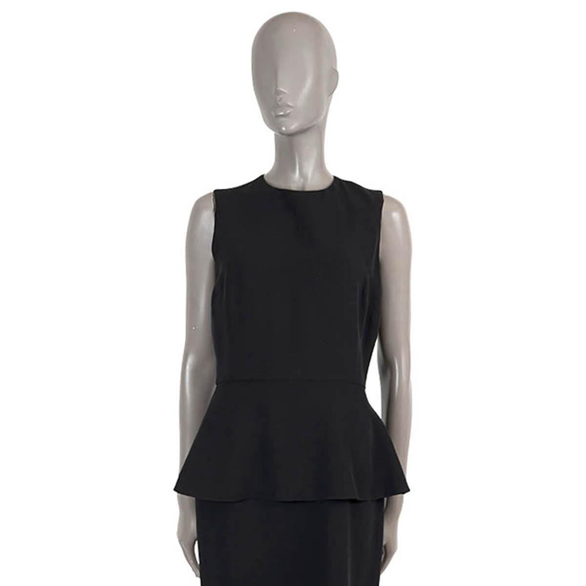 100% authentic Christian Dior sleeveless sheath dress in black silk (64%) and wool (36%). Features a crewneck and peplum. Opens with a concealed zipper and buttons in the back and is lined in silk (100%). Has been worn and is in excellent