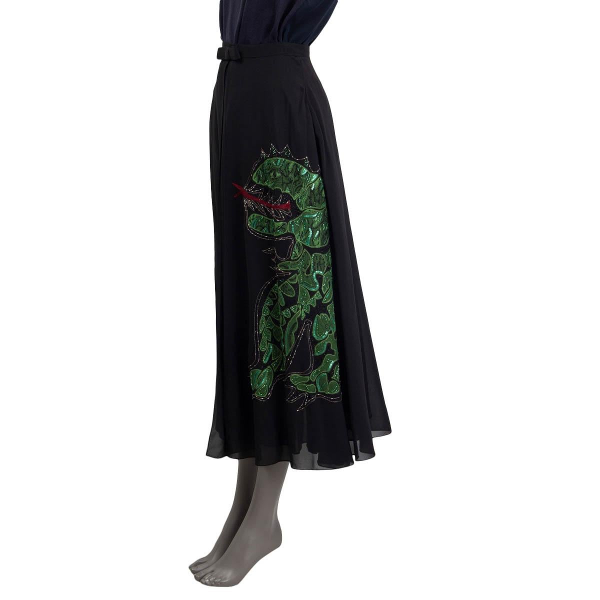 100% authentic Christian Dior 2018 midi wrap skirt in black silk (100%). Features a green dragon embroidered on the front a mesh at the front. Opens with a hook and a push button on the front. Comes with a slip skirt in black silk (100%). Has been