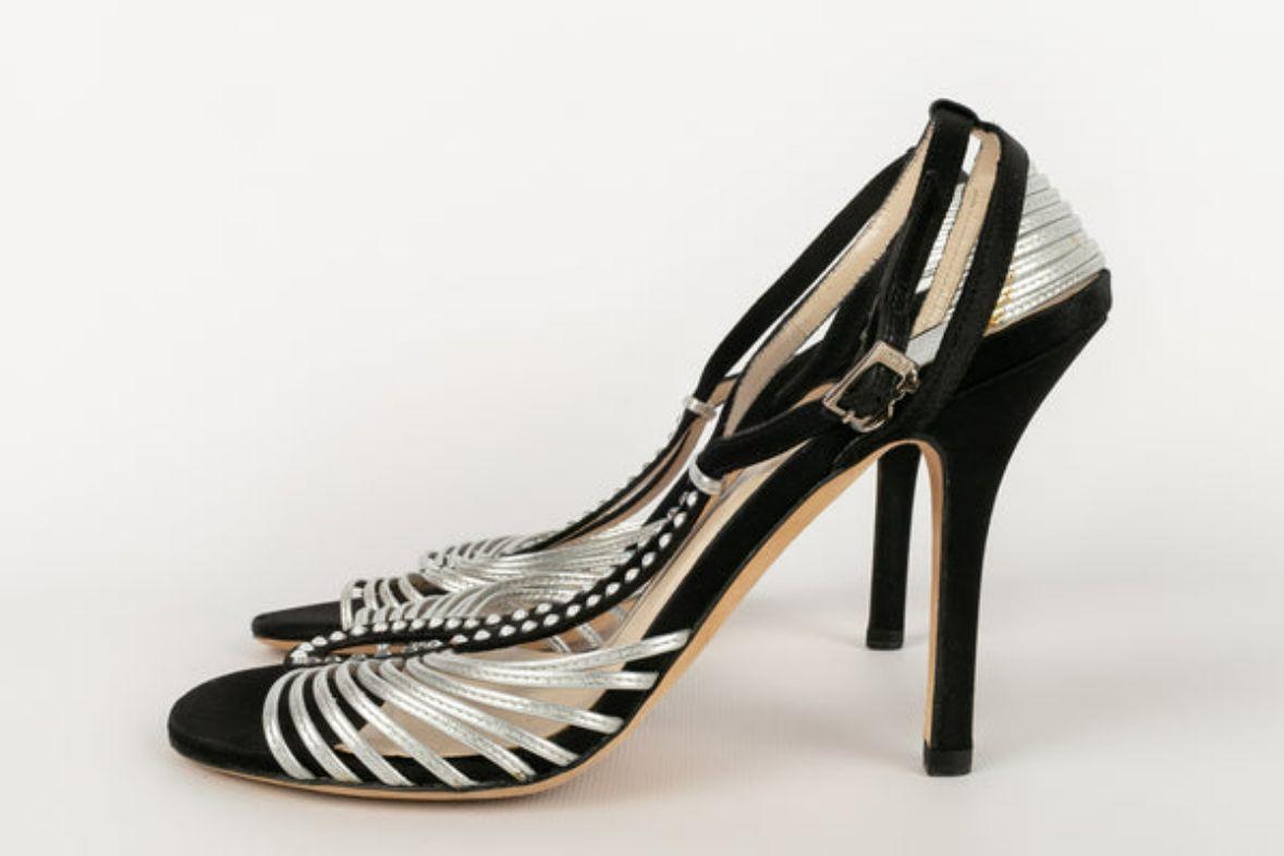 Dior - (Made in Italy) Silver leather, black suede and rhinestone pumps. Black silk heels. Size 37FR.

Additional information: 
Dimensions: Heel height: 10 cm 
Condition: Good condition 
Seller Ref number: CH48