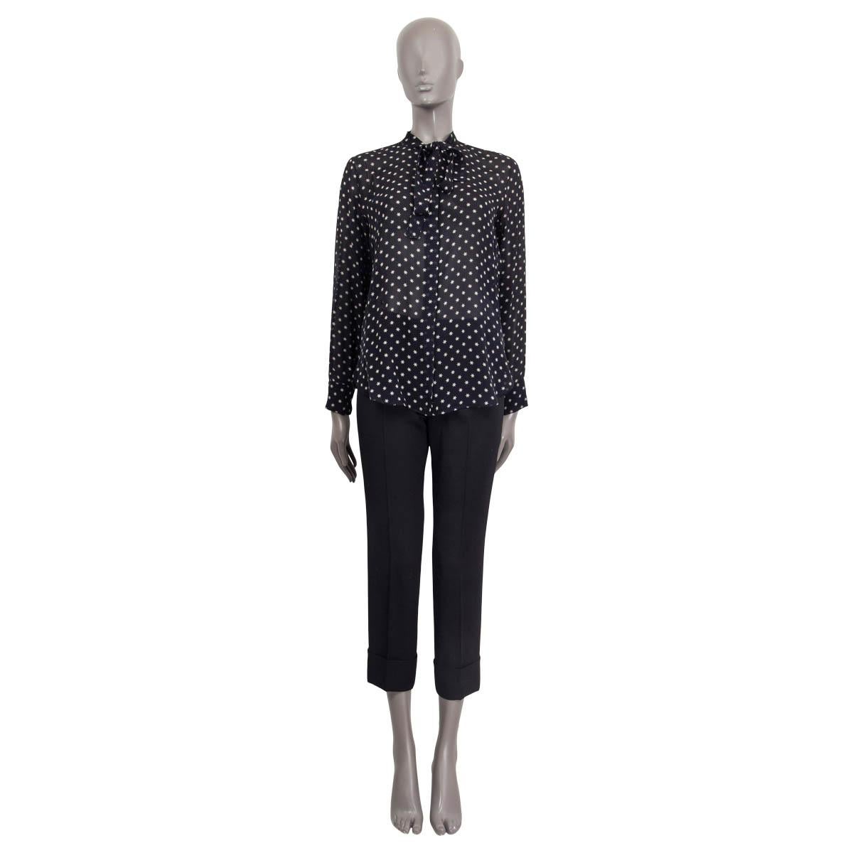 100% authentic Christian Dior star-printed blouse in black and white silk (100%). Features a tie-neck and buttoned cuffs. Opens with buttons on the front. Unlined. Has faint deodorant stains otherwise in excellent condition.

Measurements
Tag