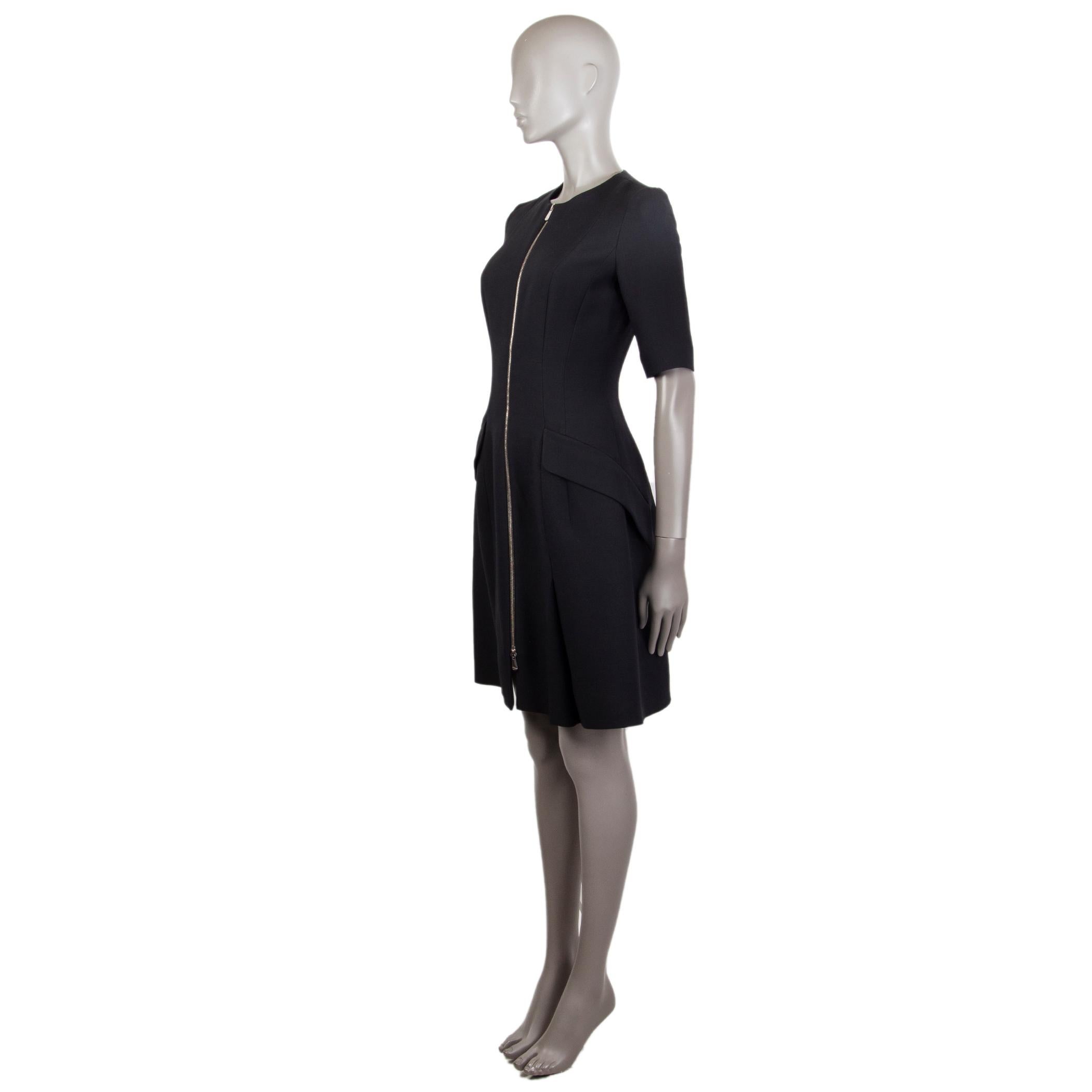 Christian Dior tailored sheath dress in black viscose blend (assumed as tag is missing) with a round neck. Has two decorative flap pockets on the front. Closes on the front with a metal tone zipper. Lined in silk (assumed as tag is missing). Fabric