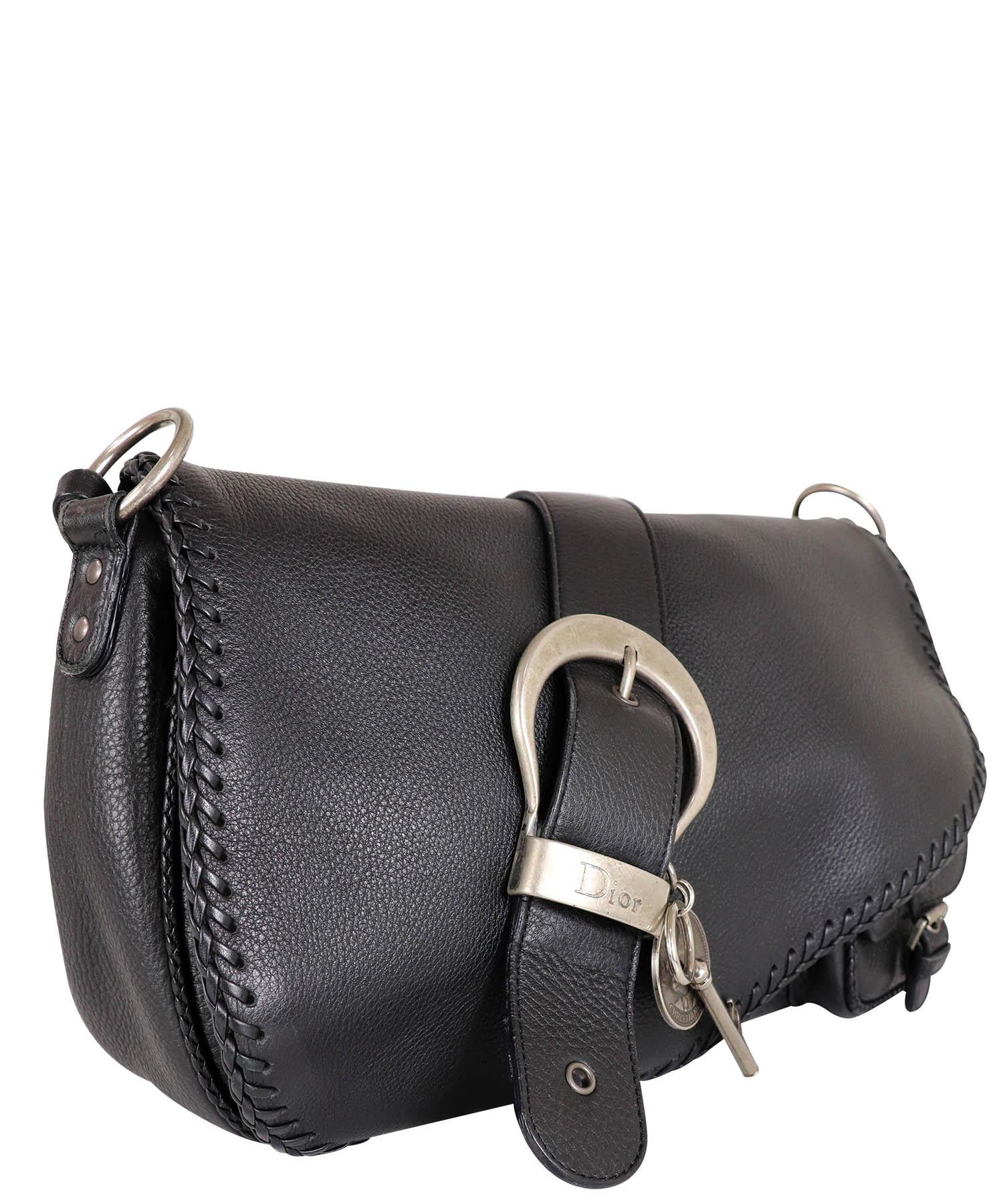 Christian Dior black calfskin leather double saddle whipstitched rare style gaucho bag from 2006. Bag has an asymmetrical front saddle flap with a magnetic closure, aged ruthenium hardware accents, a large Dior key and coin charm at the front with a