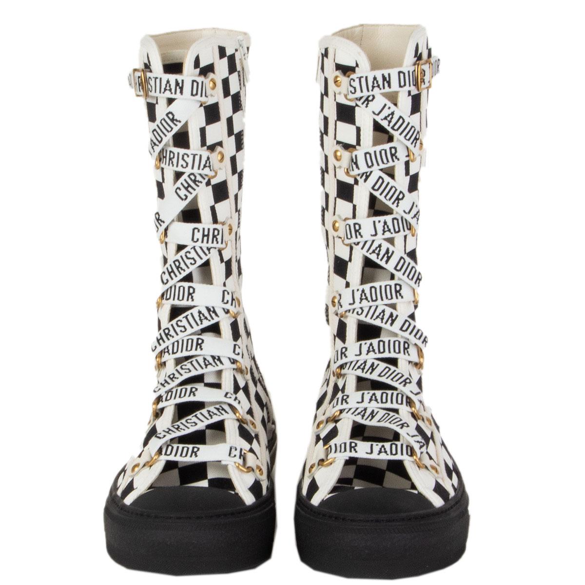 authentic Christian Dior Walk 'N' Dior booties in black and white canvas and logo lacing. Open with zipper on the inside. Brand new. Come with dust bag. 

Imprinted Size 38.5
Shoe Size 38.5
Inside Sole 25.5cm (9.9in)
Width 7.5cm (2.9in)
Shaft 24cm