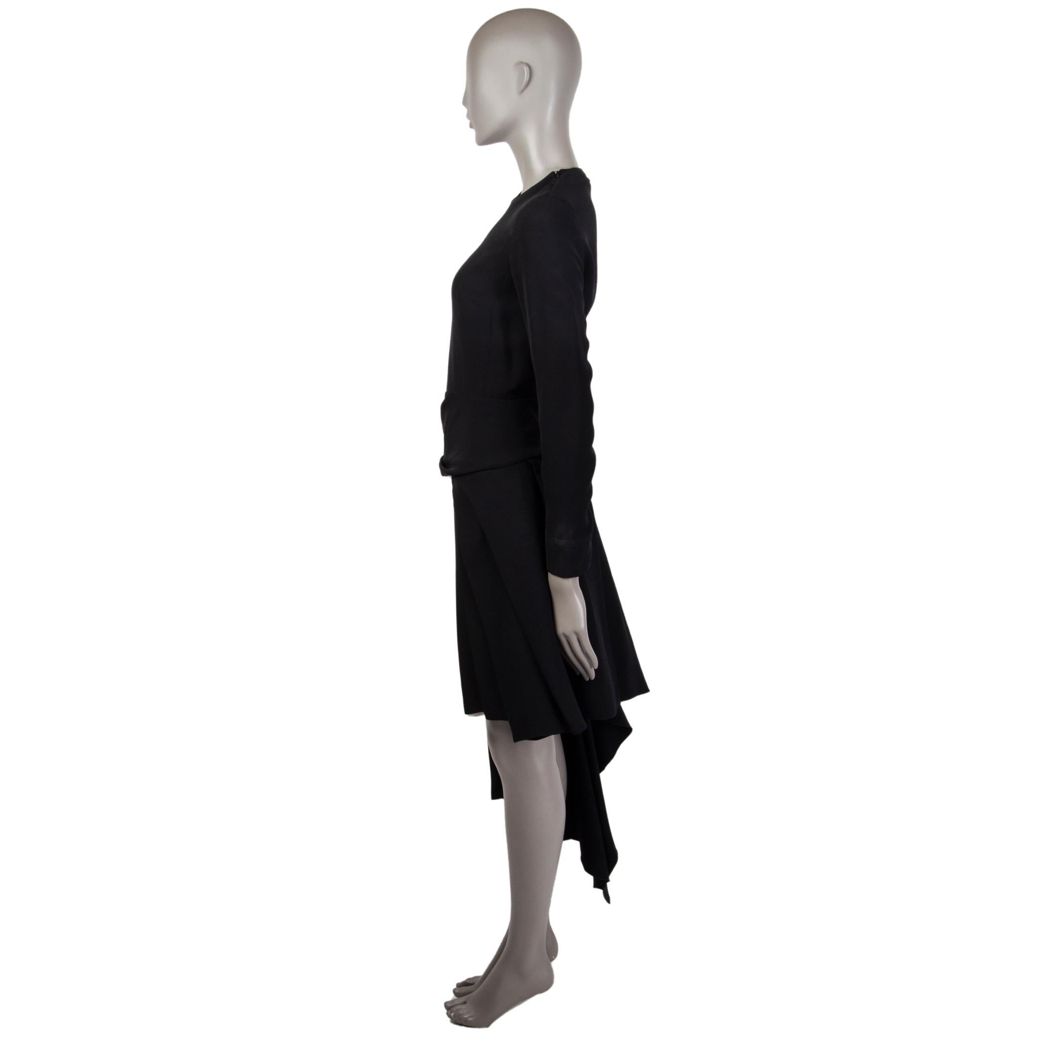 Christian Dior long-sleeve dress in black and off-white silk (100%) with a round neck. Has an asymmetrical drape-pleated detail. Closes on the side, at the cuffs and on each end of its shoulders with a concealed zipper. Lined in silk (100%). Has
