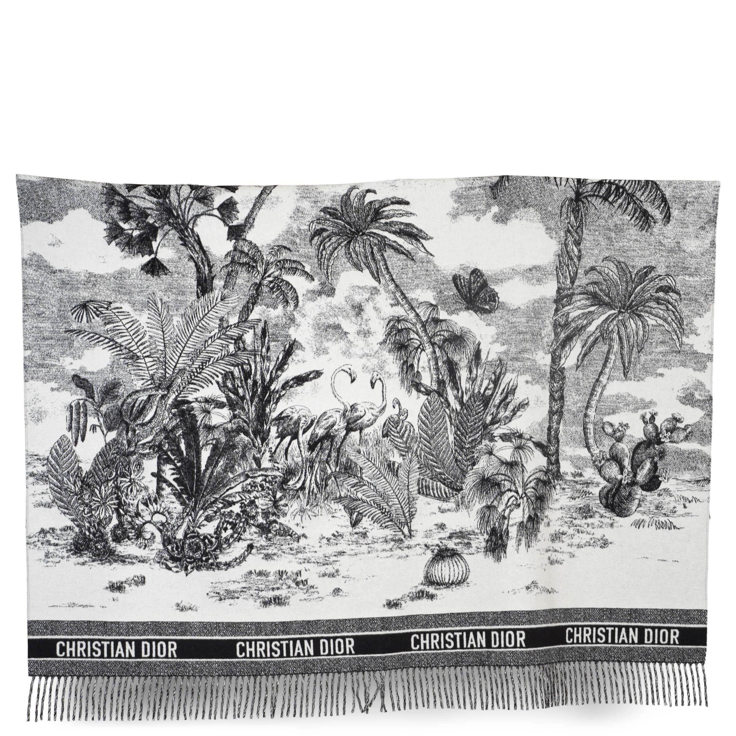 This 100% authentic Christian Dior 2019 Toile de Jouy Sauvage fringe throw blanket is crafted from luxurious black, white, and grey wool (100%), featuring the iconic Toile de Jouy Sauvage pattern. Finished with fringe detailing, this elegant throw