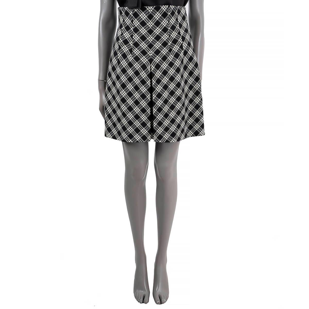 100% authentic Christian Dior Check'n'Dior mini skirt in black and white plaid wool (100% - please note the content tag is missing). Features a high waist, pleated and belt loops. Opens with a concealed zipper on the side and is lined in silk