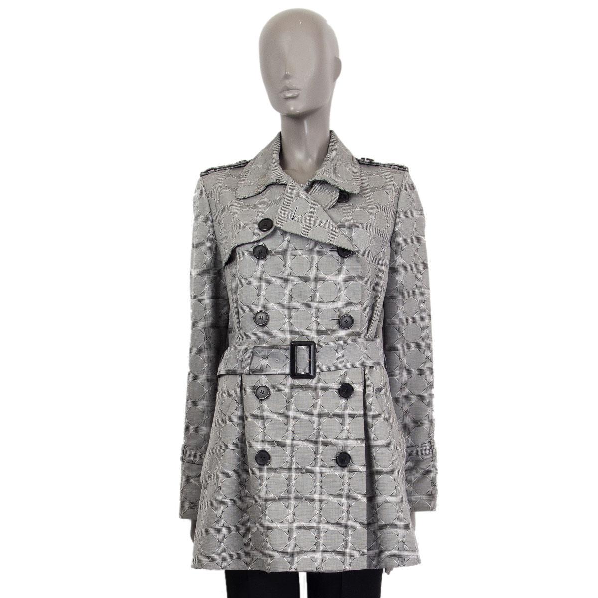 Christian Dior cannage trench coat in wool (73%) and silk (27%) with a flat collar, epaulettes and a matching belt with a black leather buckle. Cuffs have matching belts with black leather buckles. Closes on the front with buttons. Lined in silk