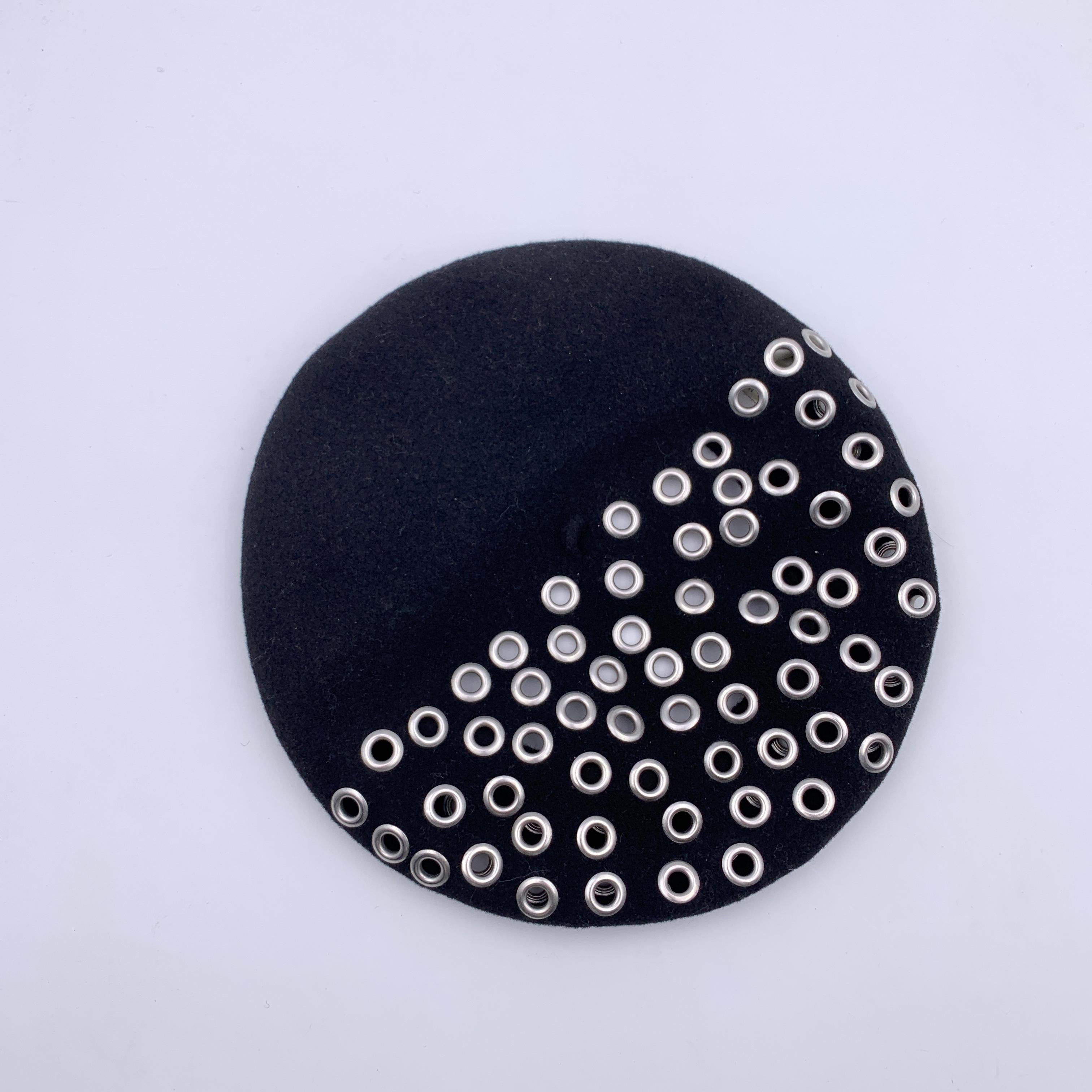 Black wool Christian Dior French beret hat with silver metal grommets detailing. Composition: 100% wool. One size Cotton trim inside. Opening diameter: 7 inches -17.8 cm. Christian Dior tag inside. Made in France

Details

MATERIAL: Wool

COLOR: