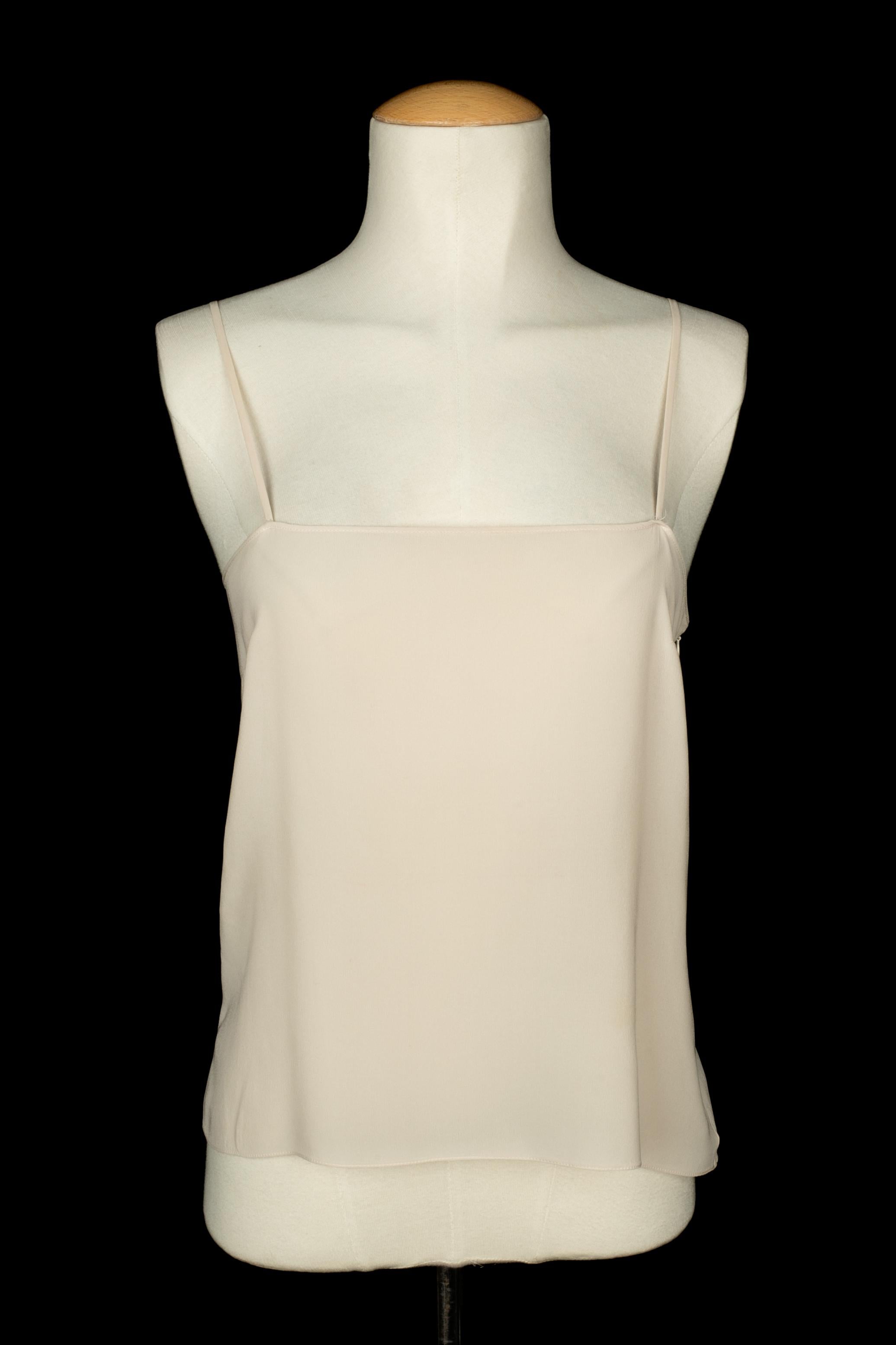 DIOR - (Made in France) White dotted-fabric blouse with long sleeves, decorated with front flounces, and with a white silk cami. No size indicated, it fits a 36FR/38FR. A Collection circa 2017, under the artistic direction of Maria Grazia