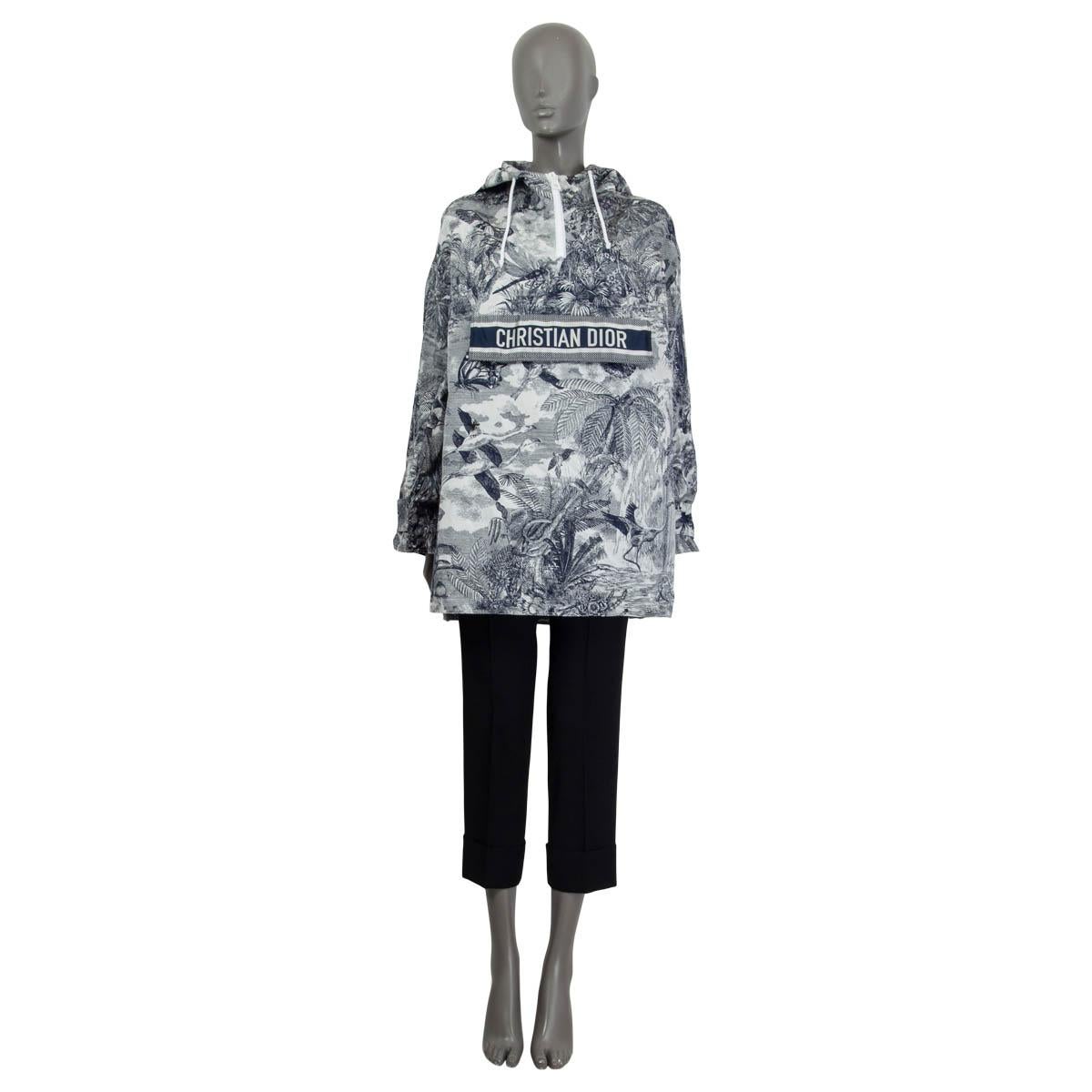 100% authentic Christian Dior hooded windbreaker jacket in off-white and navy blue Toile de Jouy Tropicalia printed technical taffeta (100% polyester). Features epaulettes at the cuffs and a 'Christian Dior' flap pocket on the front. Opens with a