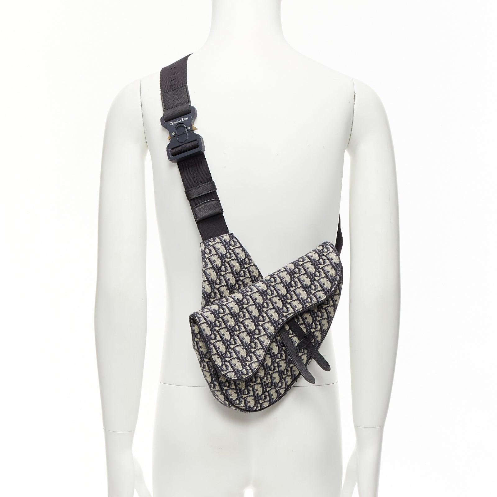 CHRISTIAN DIOR blue black CD logo monogram oblique canvas sadde shoulder bag
Reference: NKLL/A00242
Brand: Dior
Model: Saddle
Material: Canvas, Leather
Color: Black, Blue
Pattern: Monogram
Closure: Zip
Lining: Black Fabric
Extra Details: Zip closure