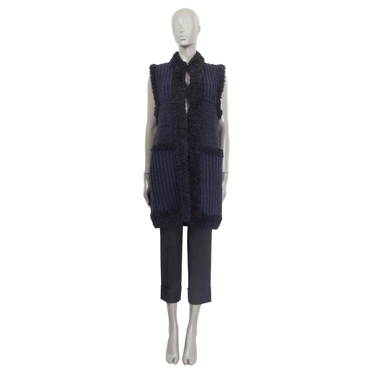 100% authentic Christian Dior sleeveless chunky knit vest in midnight blue and black wool (100%). Opens with four hooks on the front. Unlined. Has been worn and is in excellent condition. 

Measurements
Tag Size	38
Size	S
Shoulder Width	39cm