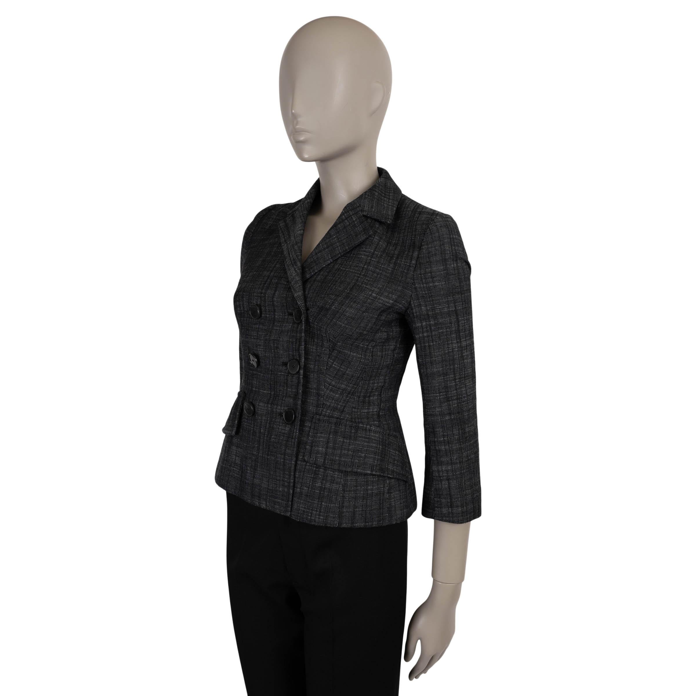 This 100% authentic Christian Dior Bar jacket is crafted in black and white canvas woven from cotton (61%), linen (20%), polyester (18%), and mulberry silk (1%). A modern take on Dior’s iconic silhouette, it features a double-breasted, fitted cut