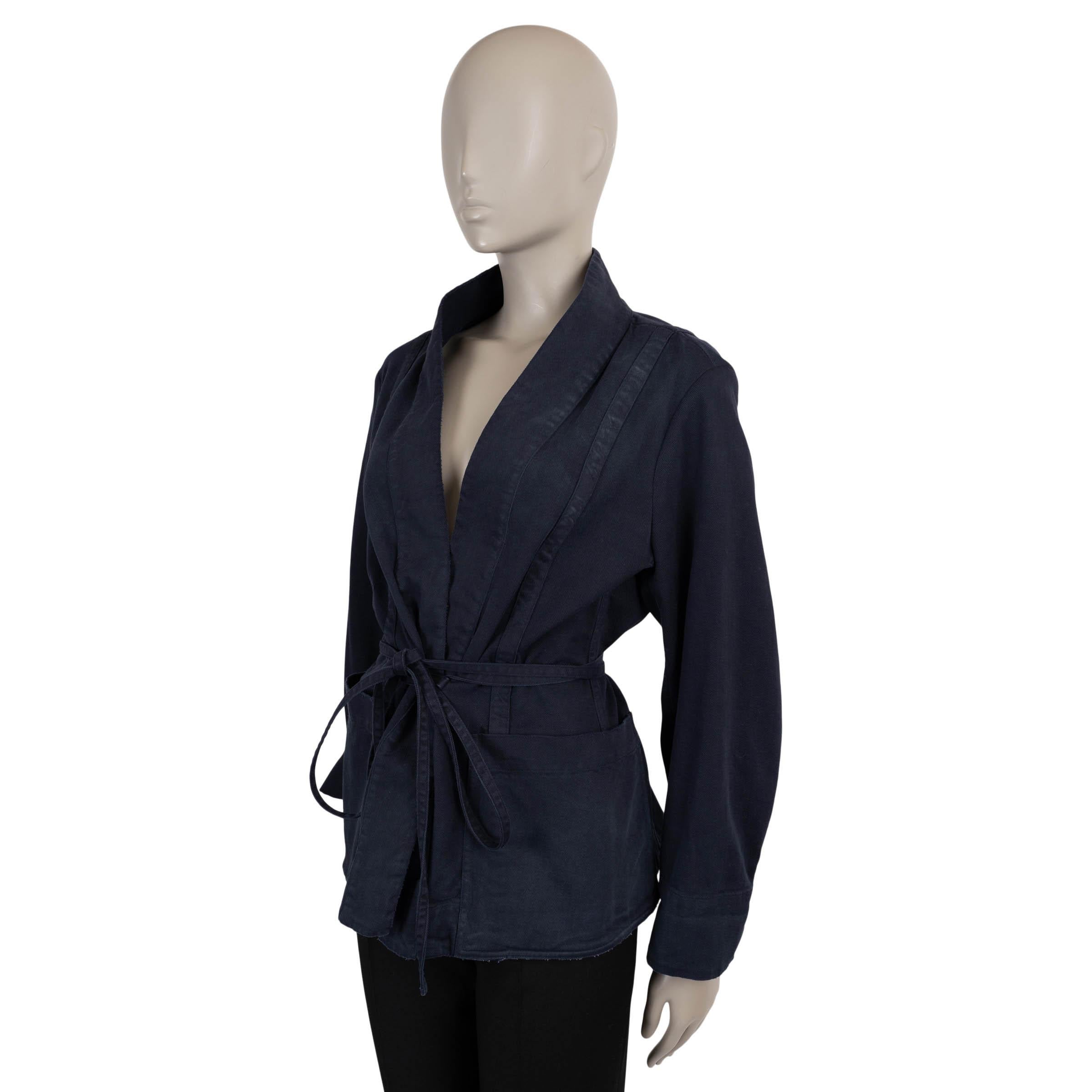 Christian Dior kimono jacket in indigo blue washed denim cotton (with 2% elastane). Features a relaxed silhouette with a wrap front, shawl collar, tonal bee embroidery, and two patch pockets. Ties at the waist with a thin self-belt for a sculpted