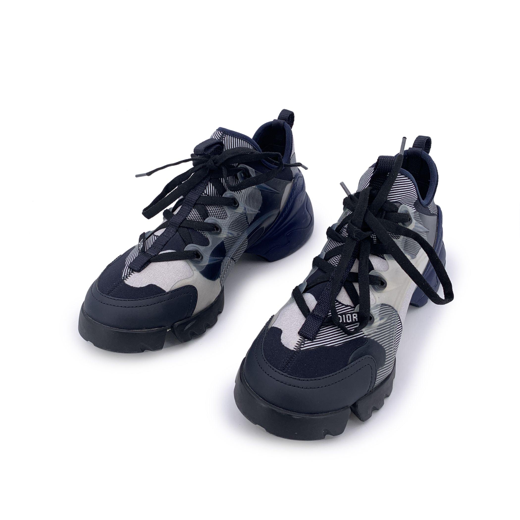 Bold, futuristic, and unmistakably Dior - the Christian Dior D-Connect sneakers reimagine athletic style with high-fashion precision. Crafted in layered technical fabric in cool blue tones, this standout pair features sculptural rubber details, a