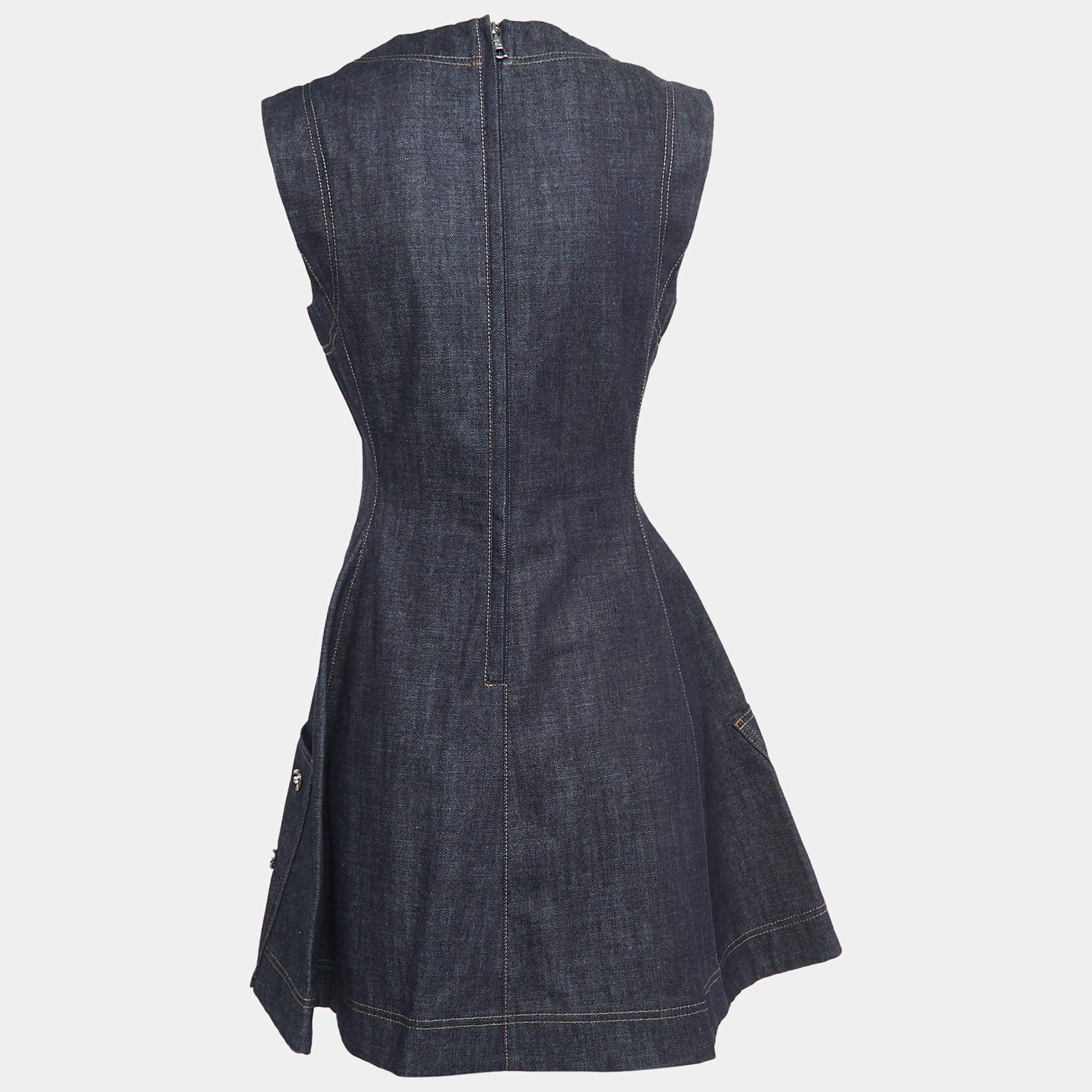 The Christian Dior dress effortlessly combines casual denim with glamorous accents. Featuring intricate embellishments, this sleeveless dress exudes a modern and playful charm, making it a stylish choice for any occasion.

