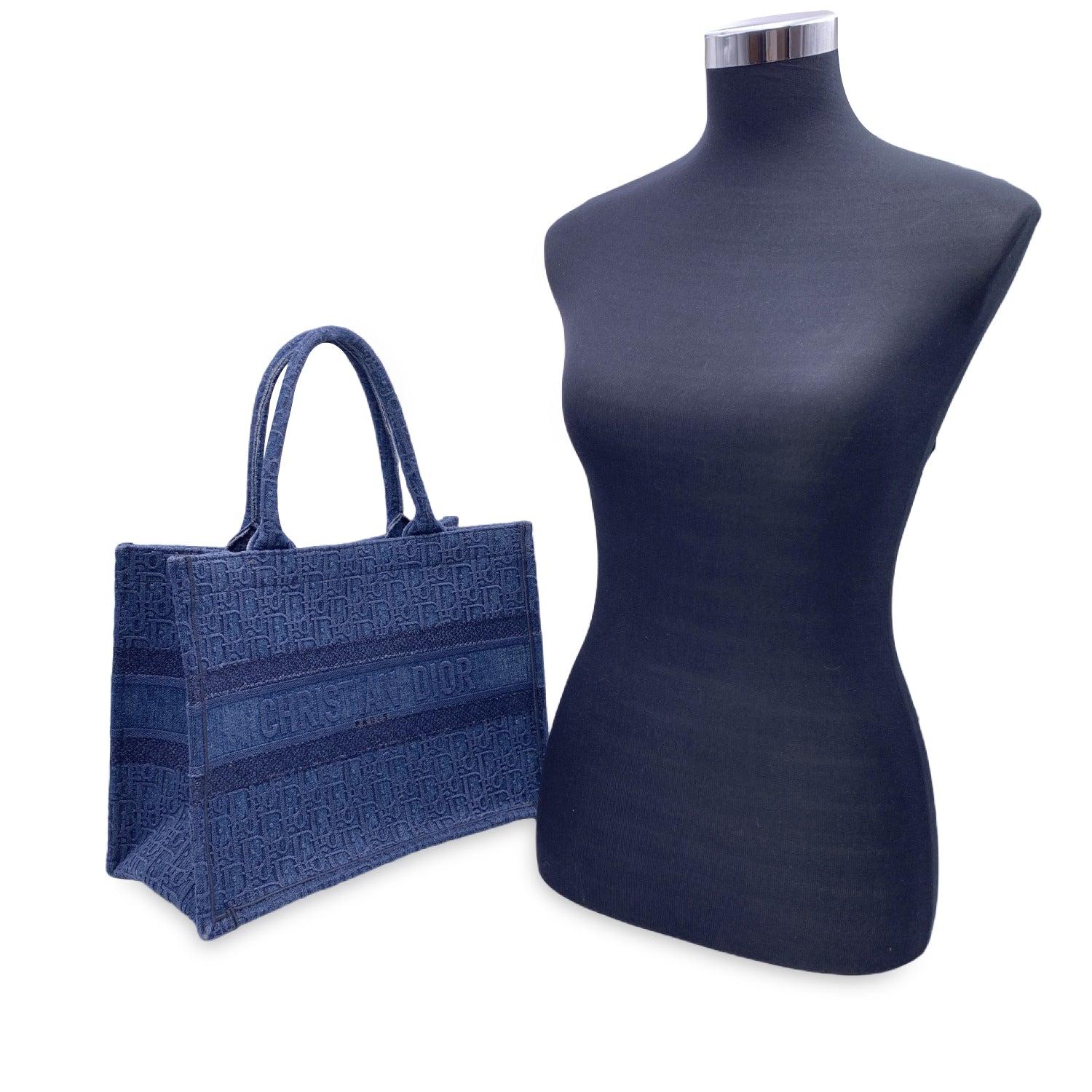 Iconic Christian Dior blue Oblique denim canvas 'Book Tote' from the 2019 Fall/Winter collection.. This is the Medium size. It features and open top and double top handles. It is embellished with the 'CHRISTIAN DIOR PARIS' writing on the front,