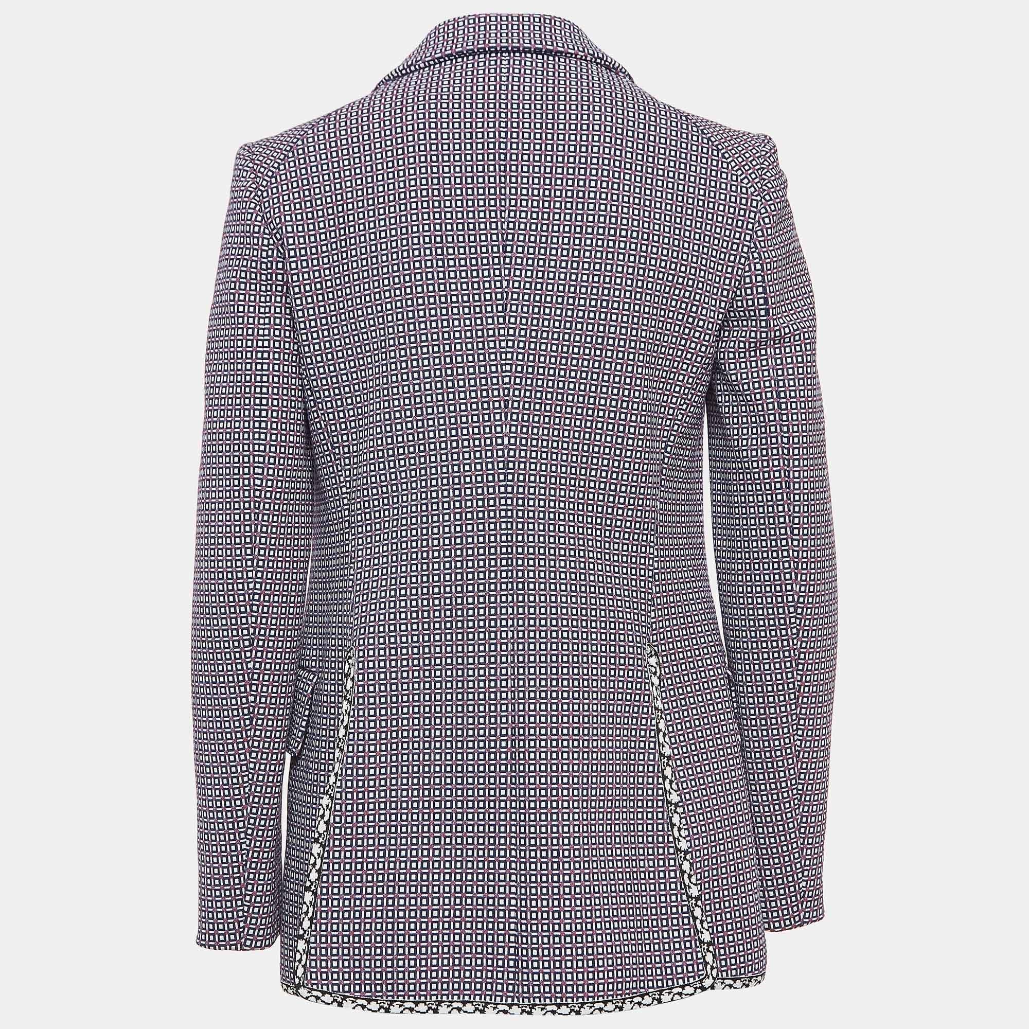 Crafted by Christian Dior, this blazer boasts a mesmerizing blue geometric pattern, adding a contemporary twist to a classic silhouette. Tailored in premium cotton, it features a single-breasted design exuding refinement. Versatile yet striking, it