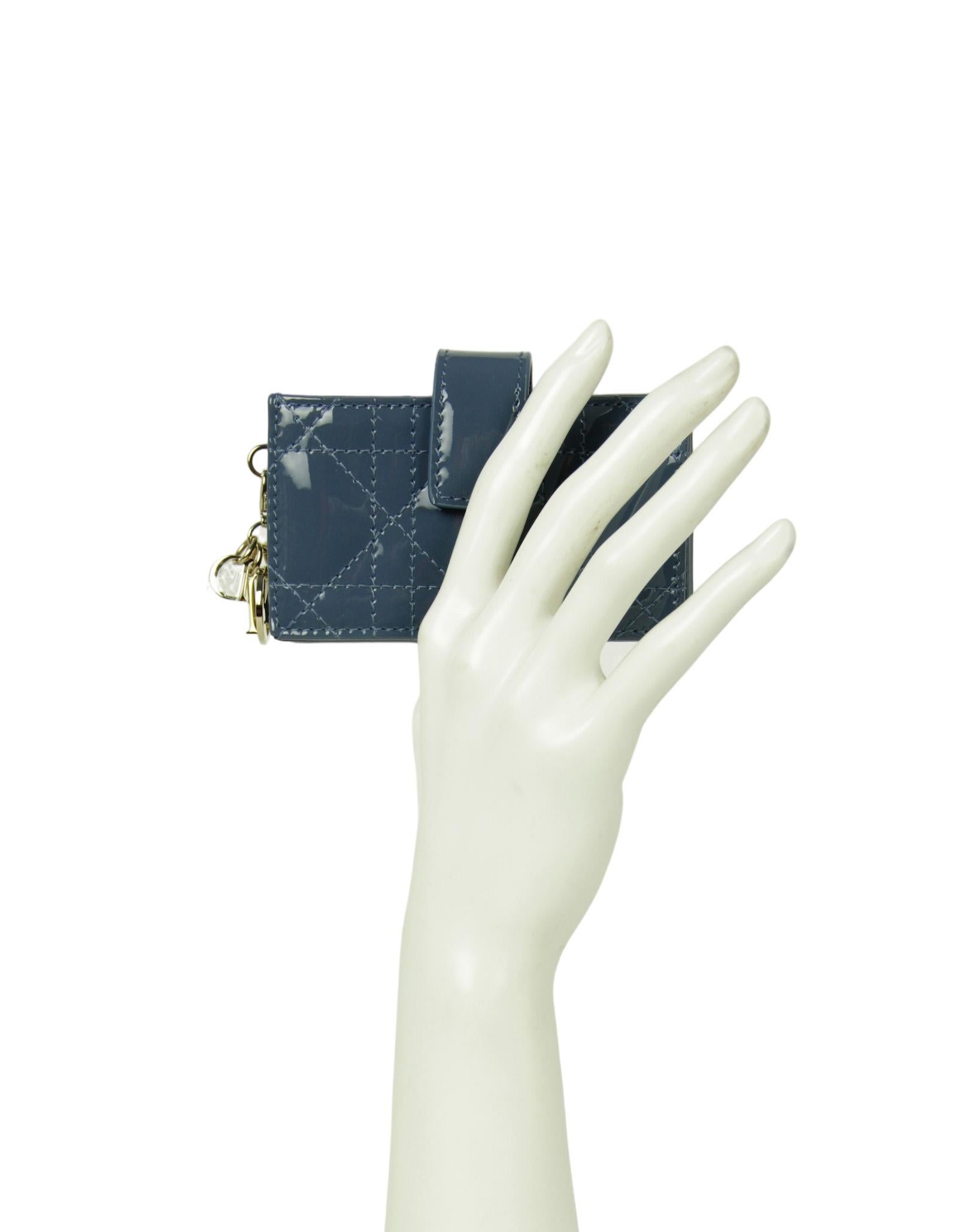 Christian Dior Blue Patent Leather Lady Dior Jasmine Card Holder Wallet

Color: Blue
Hardware:  Pale goldtone
Materials: Patent leather
Closure/Opening: Tab with snap
Exterior Pockets: None
Interior Pockets: Five gusseted compartments
Exterior