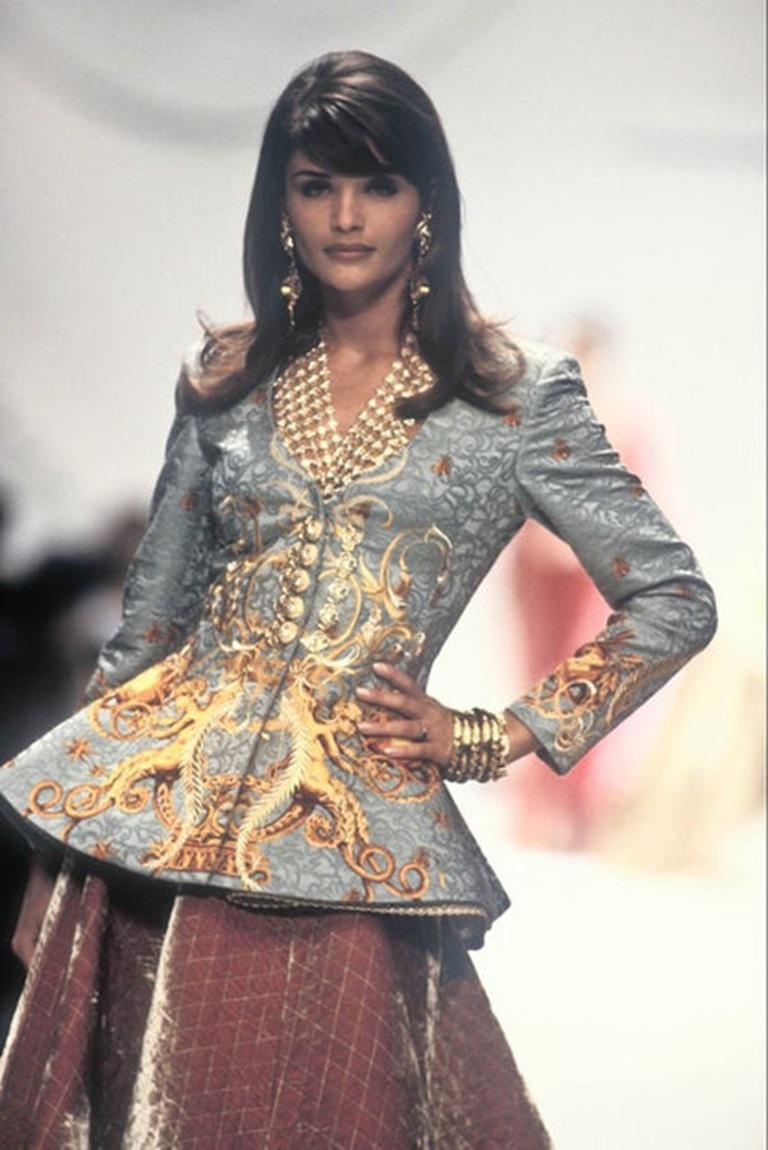 Dior - (Made in France) Blue silk and wool Jacquard jacket with golden embroidery and rhinestoned golden metal buttons. Size 38FR indicated. 1992-1993 Fall-Winter Collection, under the artistic direction of Gianfranco Ferré.

Additional