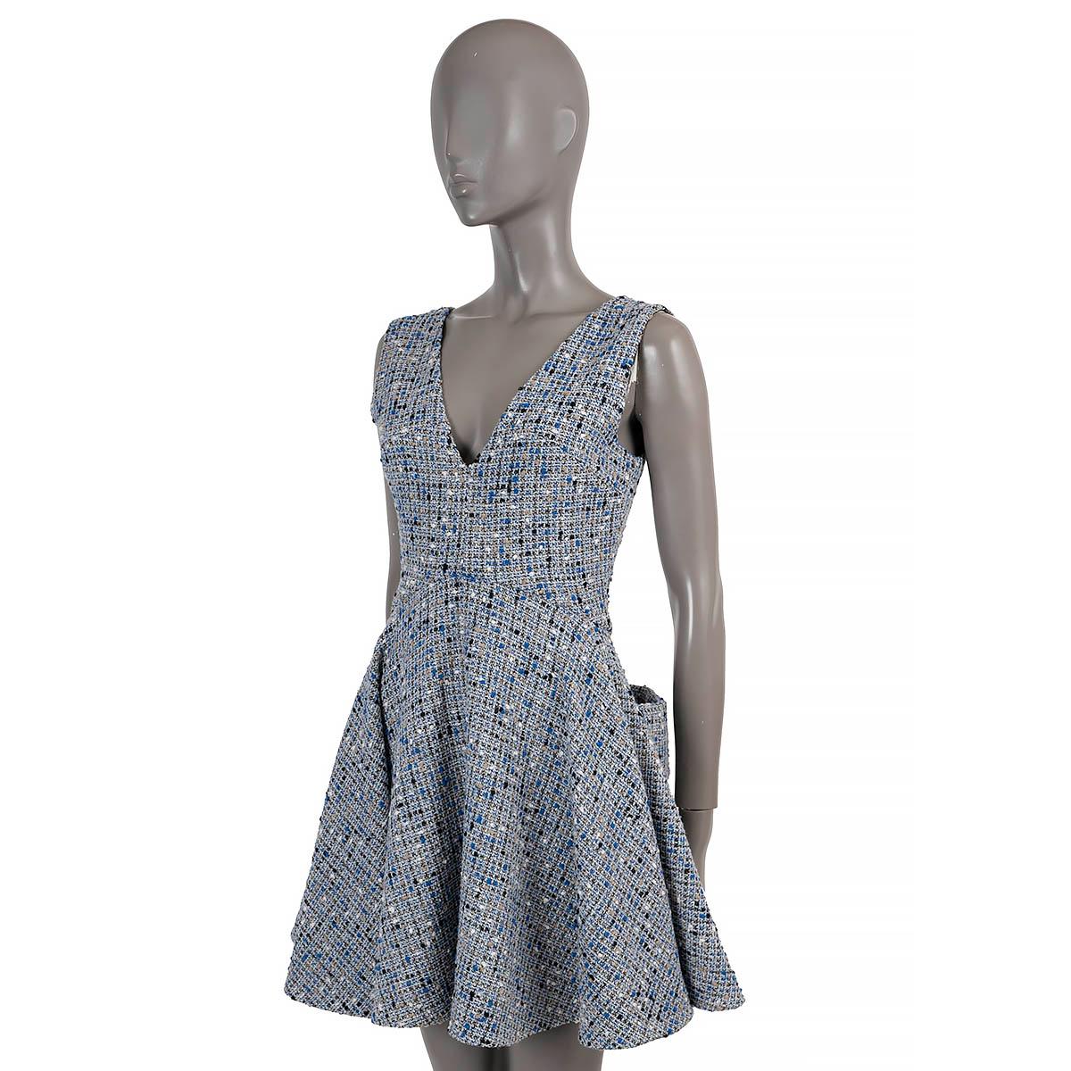 100% authentic Christian Dior sleeveless tweed dress in grey, white, beige, black and blue wool (89%) and polyamide (11%). Features a tailored V-neck top and flared skirt with two pockets on the back. Opens with a concealed zipper in the back and is