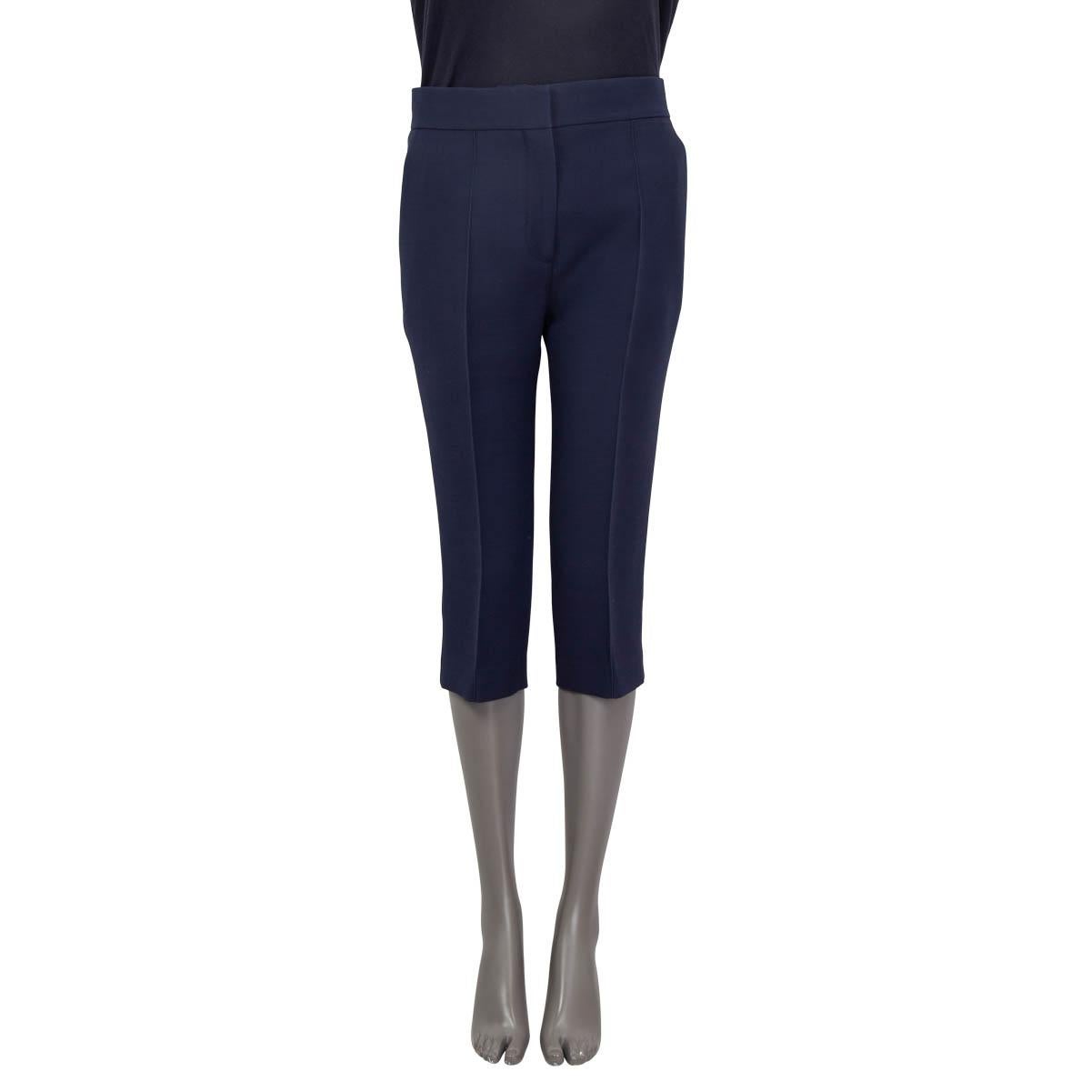 100% authentic Christian Dior below-knee suit pants in navy blue wool (77%) and silk (23%). Features two two slit pockets on the front and two slit pockets on the back. Opens with a concealed hook, button and zipper on the front. Unlined. Have been