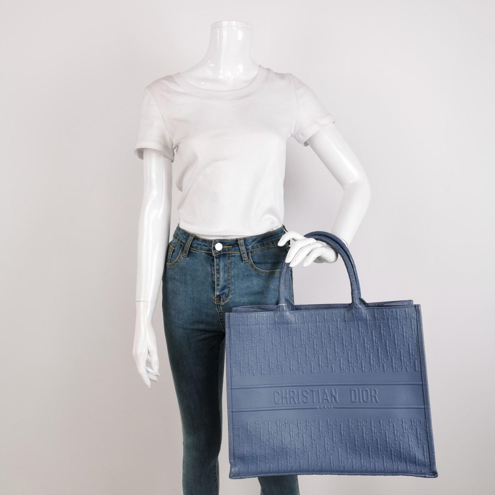 Christian Dior Book Tote Large Blue Calfskin Leather Oblique Embossed Handbag These are professional photos of the actual bag. Made with a premium combination of calfskin leather and suede, this blue Dior Book Tote offers a luxurious twist on the