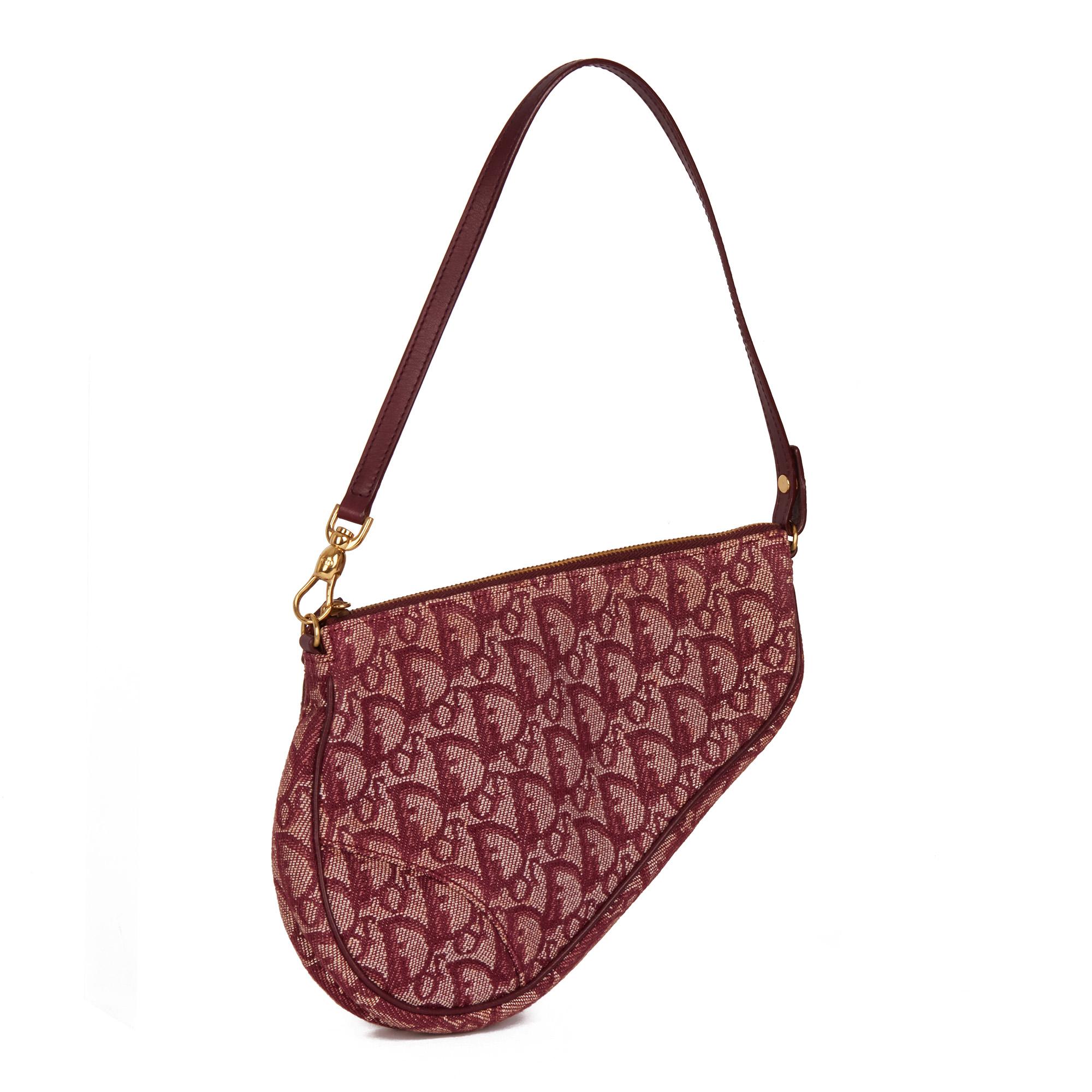 CHRISTIAN DIOR
Bordeaux Monogram Canvas & Calfskin Leather Vintage Mini Saddle Bag 

Xupes Reference: HB4360
Serial Number: MC 0062
Age (Circa): 2002
Authenticity Details: Date Stamp (Made in Spain)
Gender: Ladies
Type: Shoulder, Top Handle

Colour: